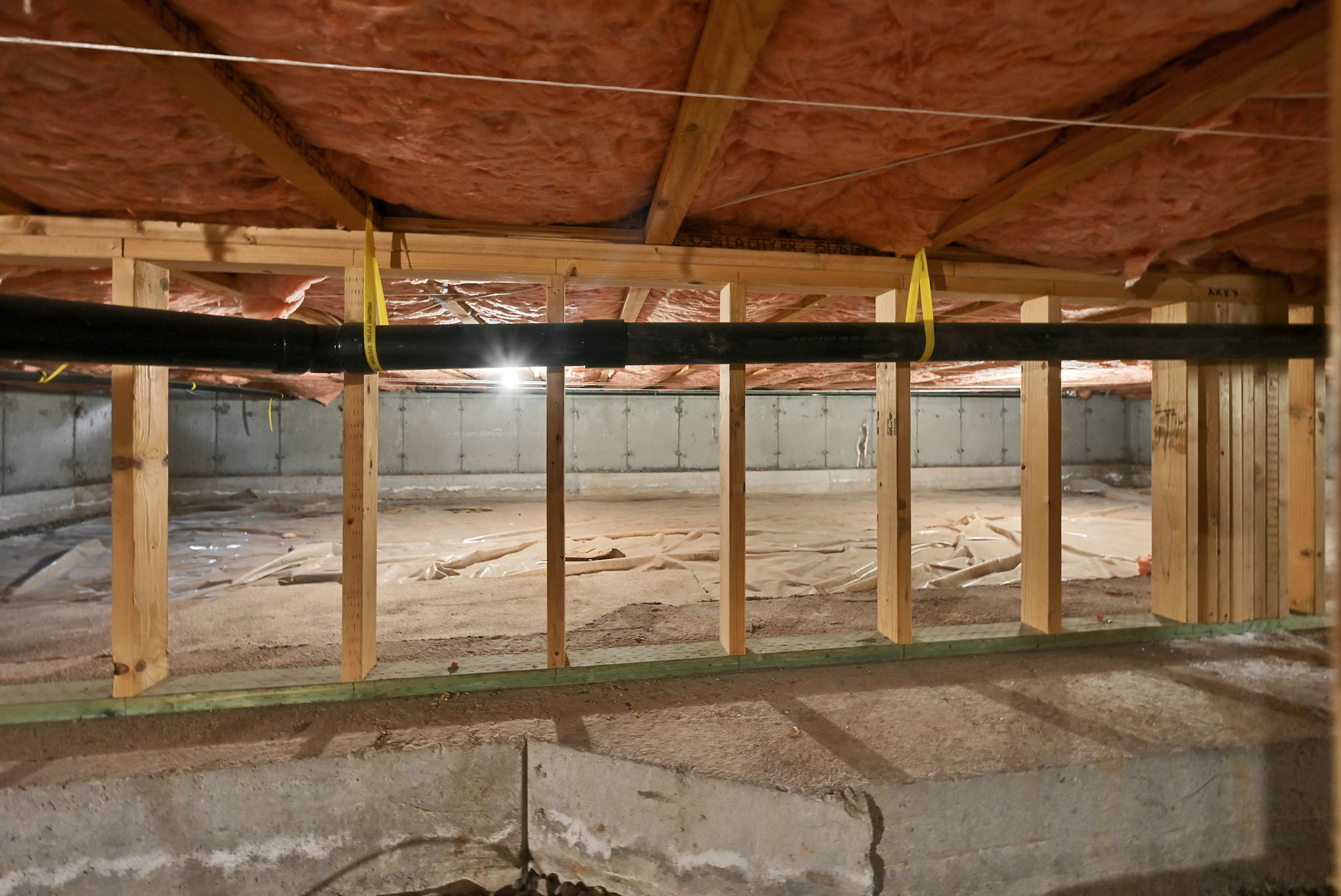 Useable, lighted Crawl space with wood framing, insulated ceiling, and vapor barrier across the ground