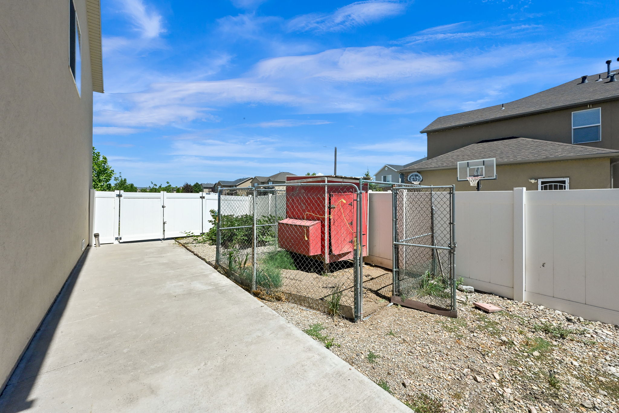 CHICKEN COOP Concrete walkway alongside the property