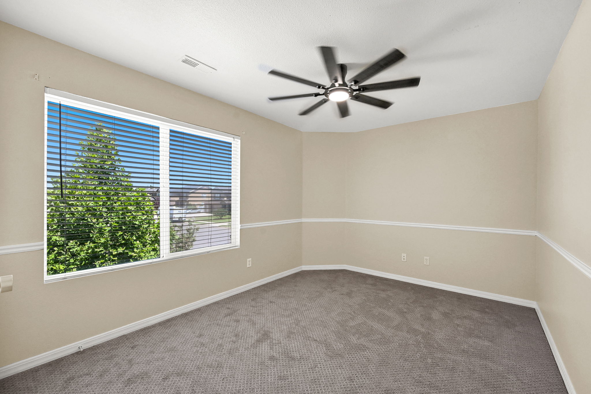 BEDROOM 2  with neutral wall paint, gray carpeting, and a modern ceiling fan