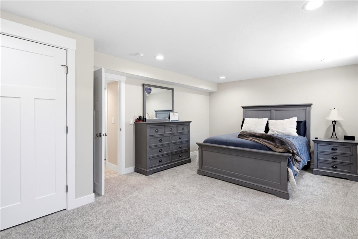 Carpeted room with recessed lighting and a neutral wall color