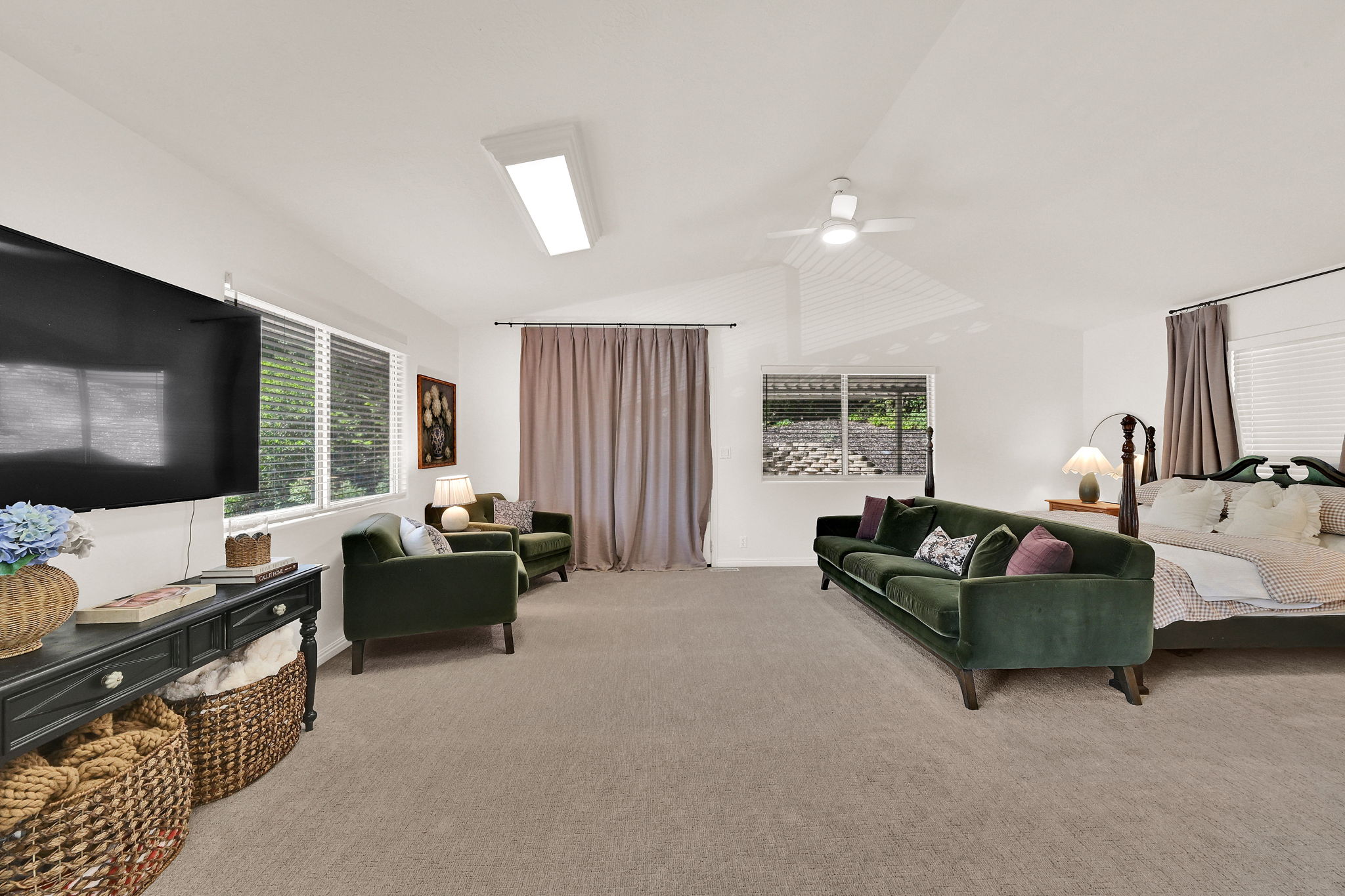 Spacious owners suite with vaulted ceilings and neutral carpeting