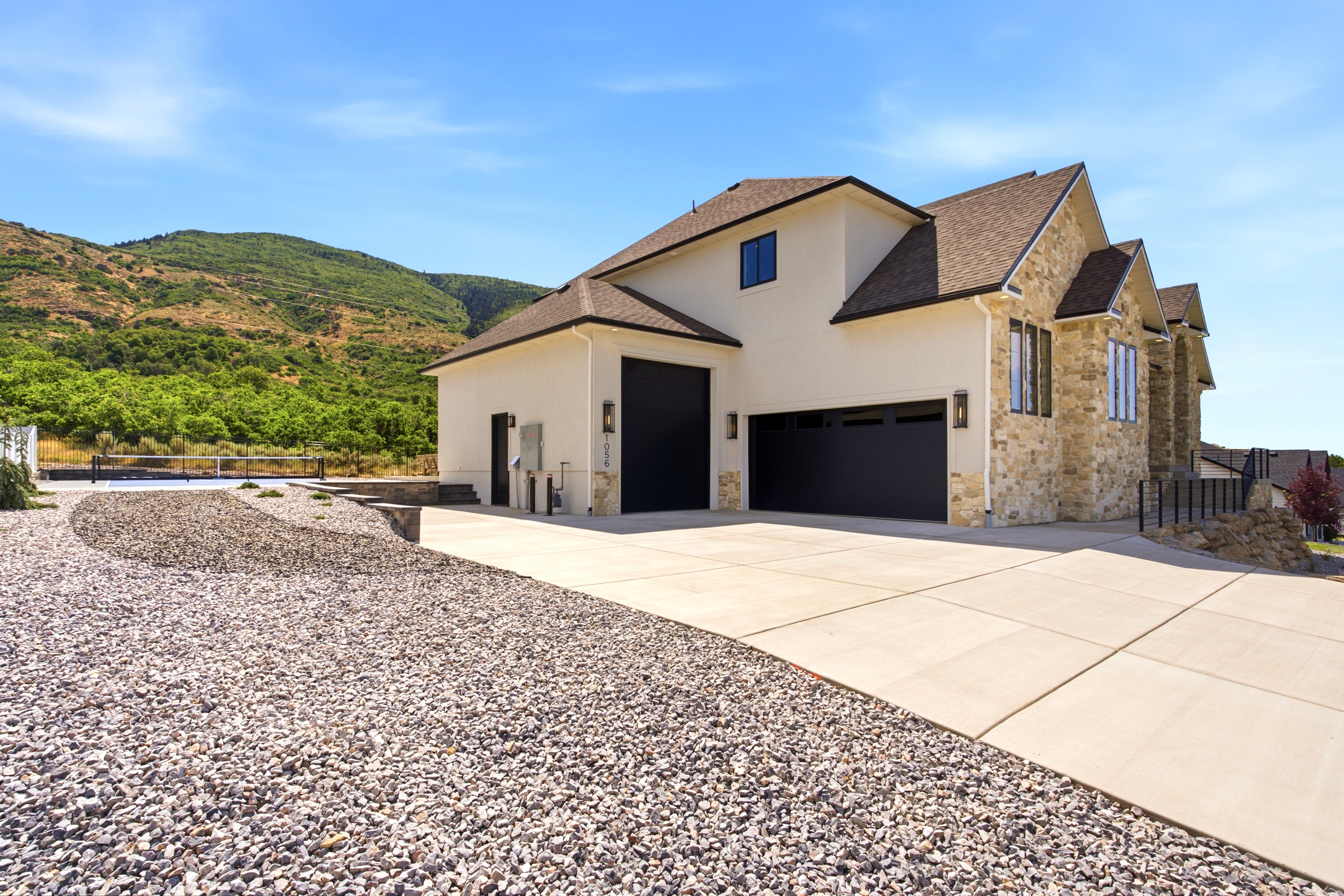 Contemporary exterior featuring stone veneer and stucco finishes