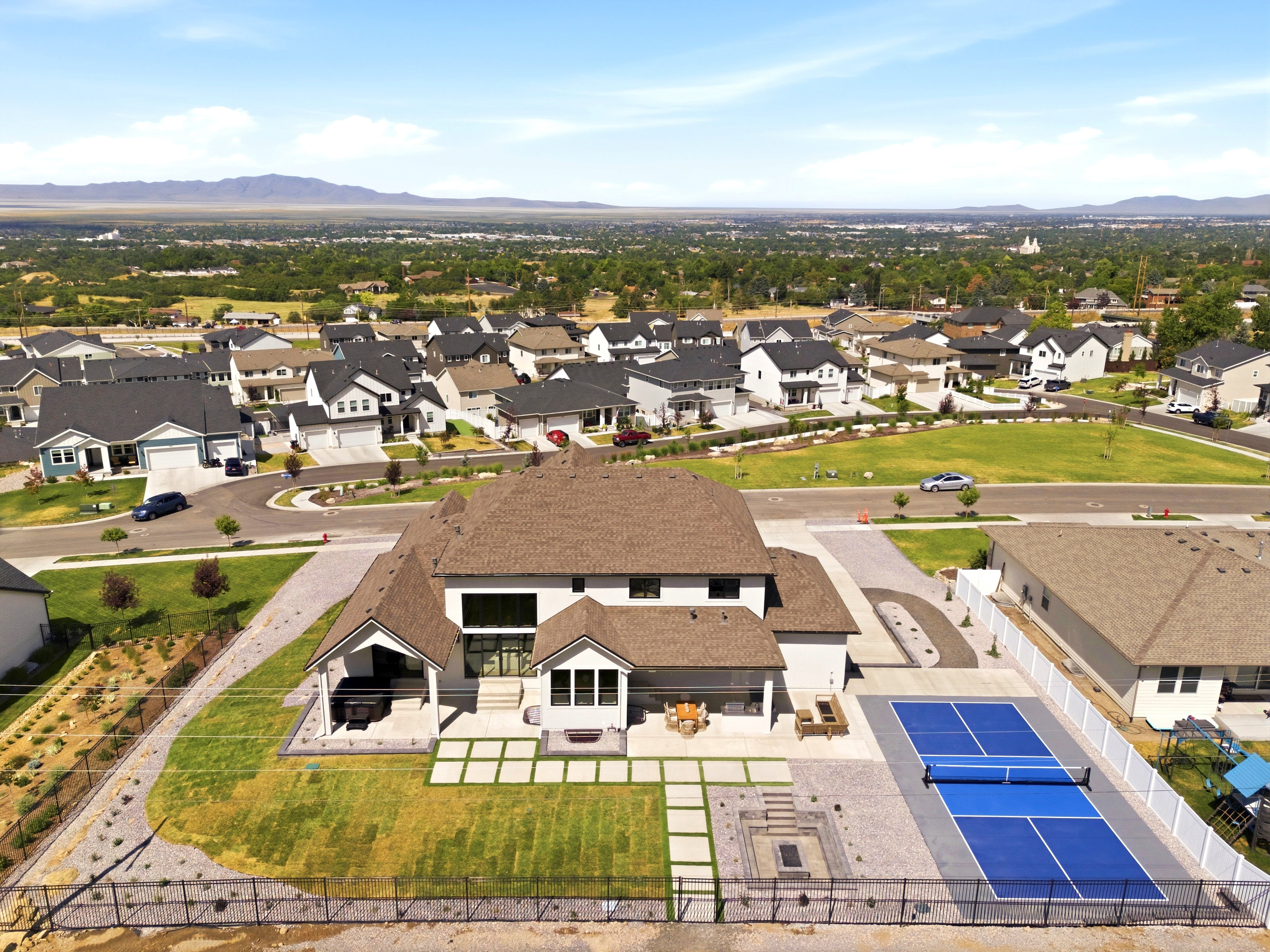 Expansive property featuring a private sport court, integrated fire pit area, and a covered patio
