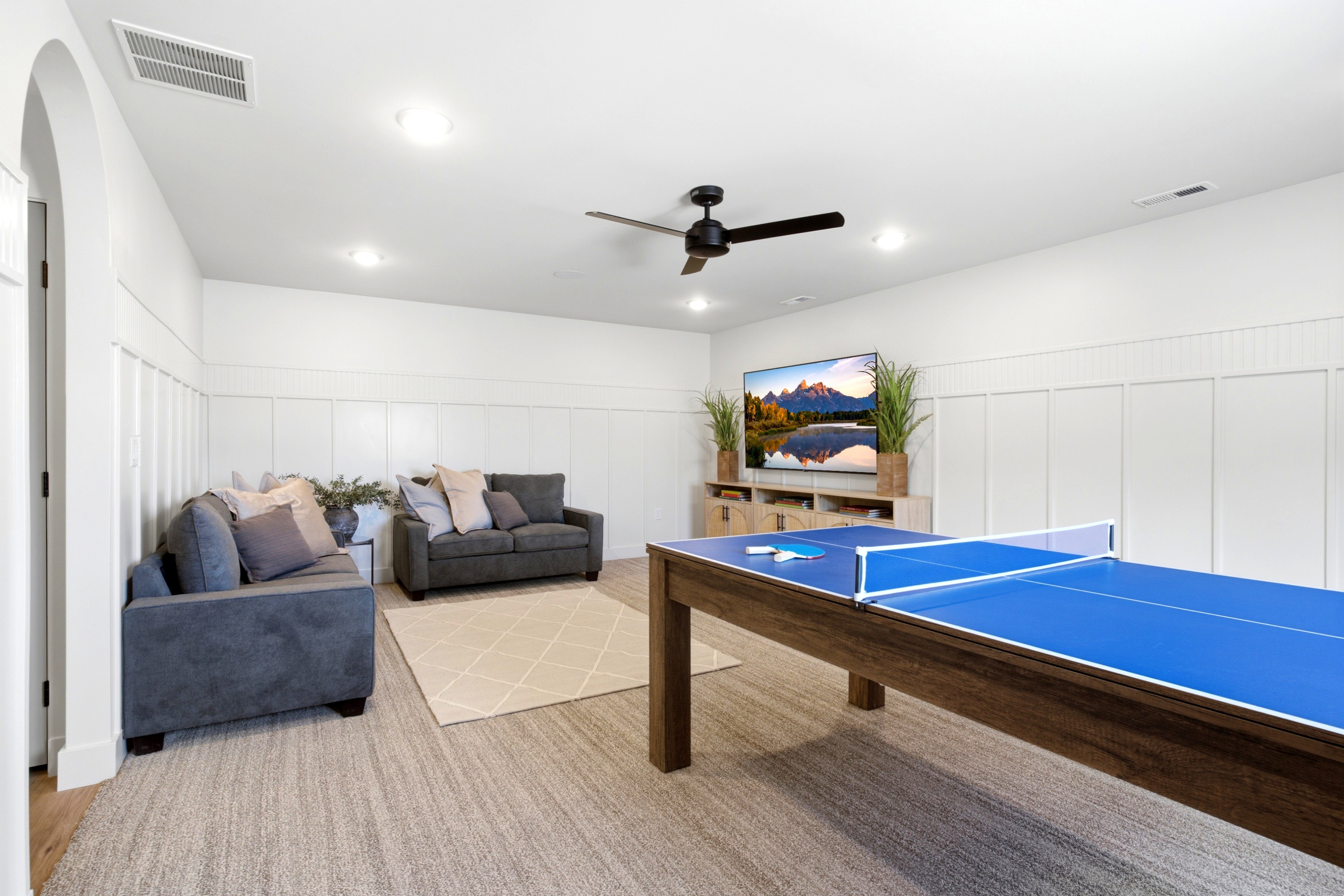 Spacious entertainment area featuring board and batten wall detailing