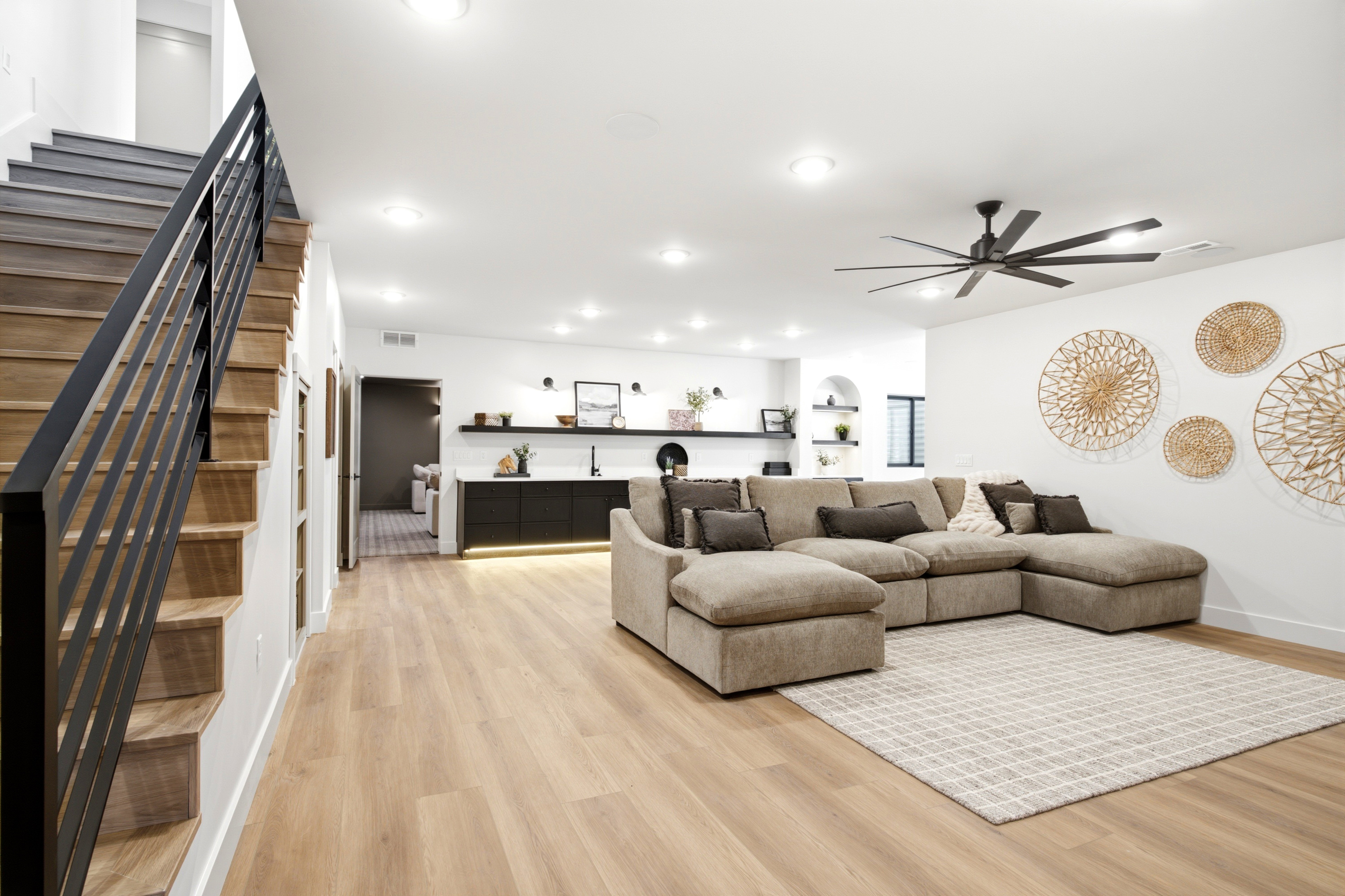 Open-concept living area featuring wood-finish flooring, recessed lighting, and a contemporary ceiling fan