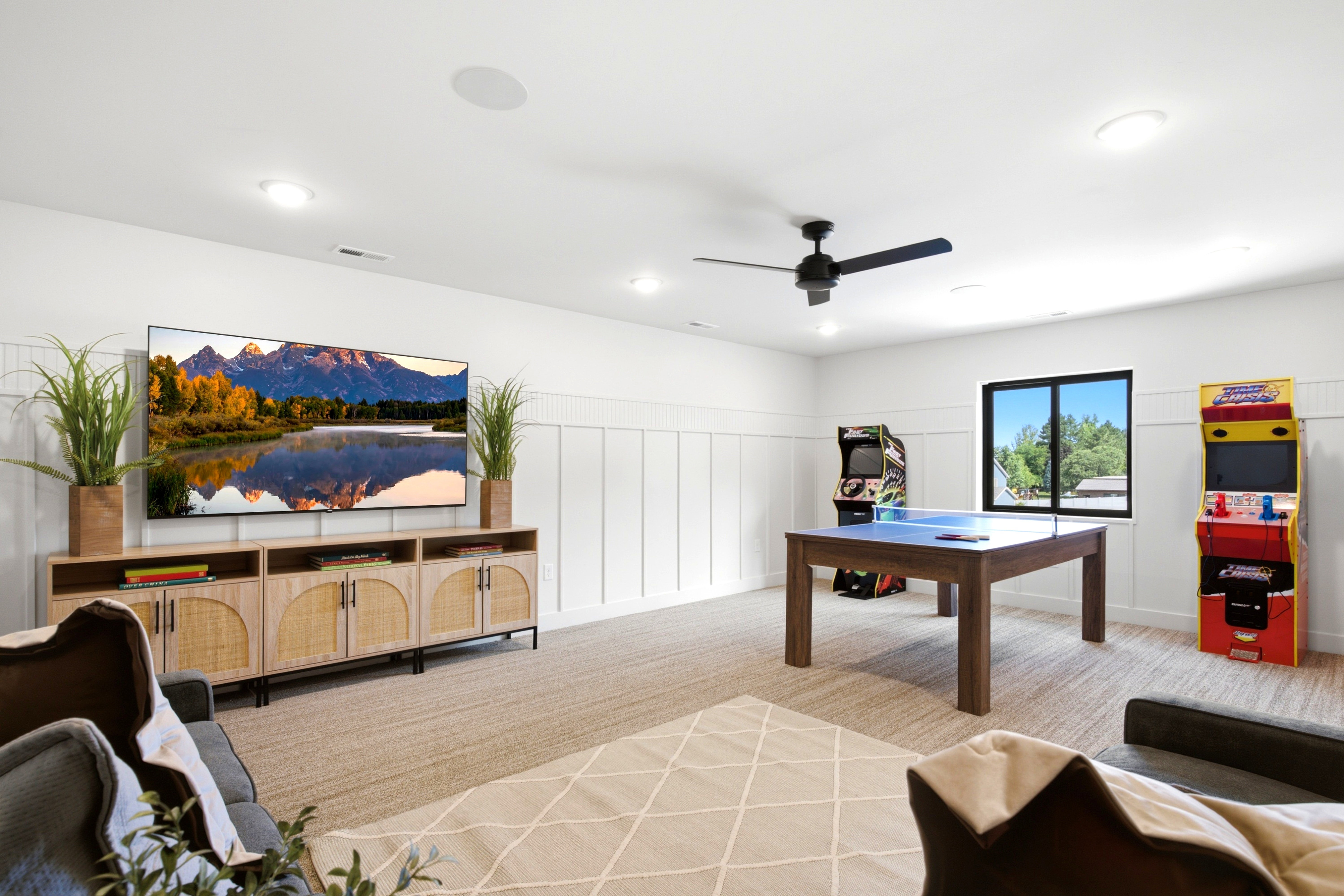 Spacious recreation room featuring wainscoting, recessed lighting, and a neutral carpet