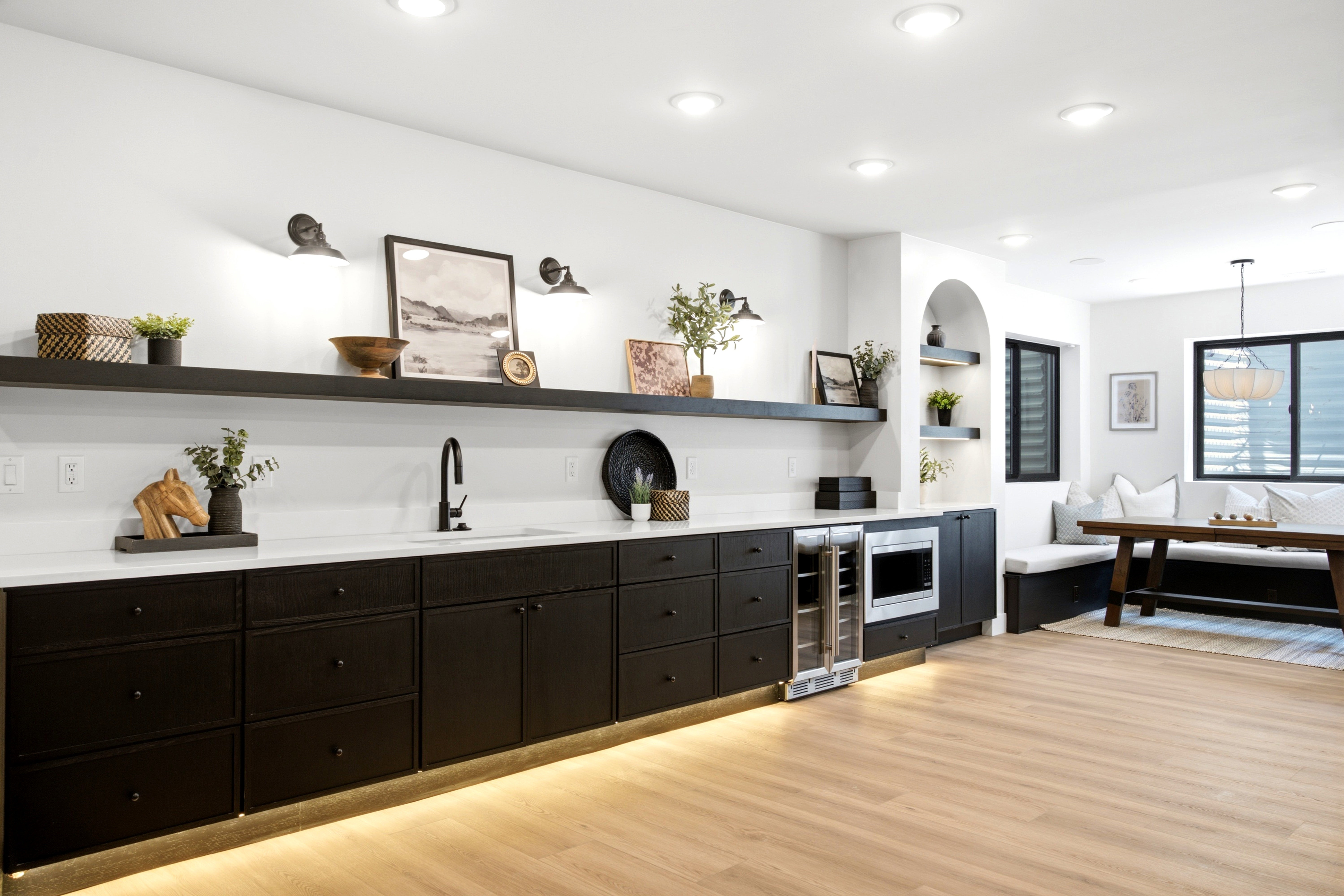 Expansive entertainment space featuring light wood-finish flooring