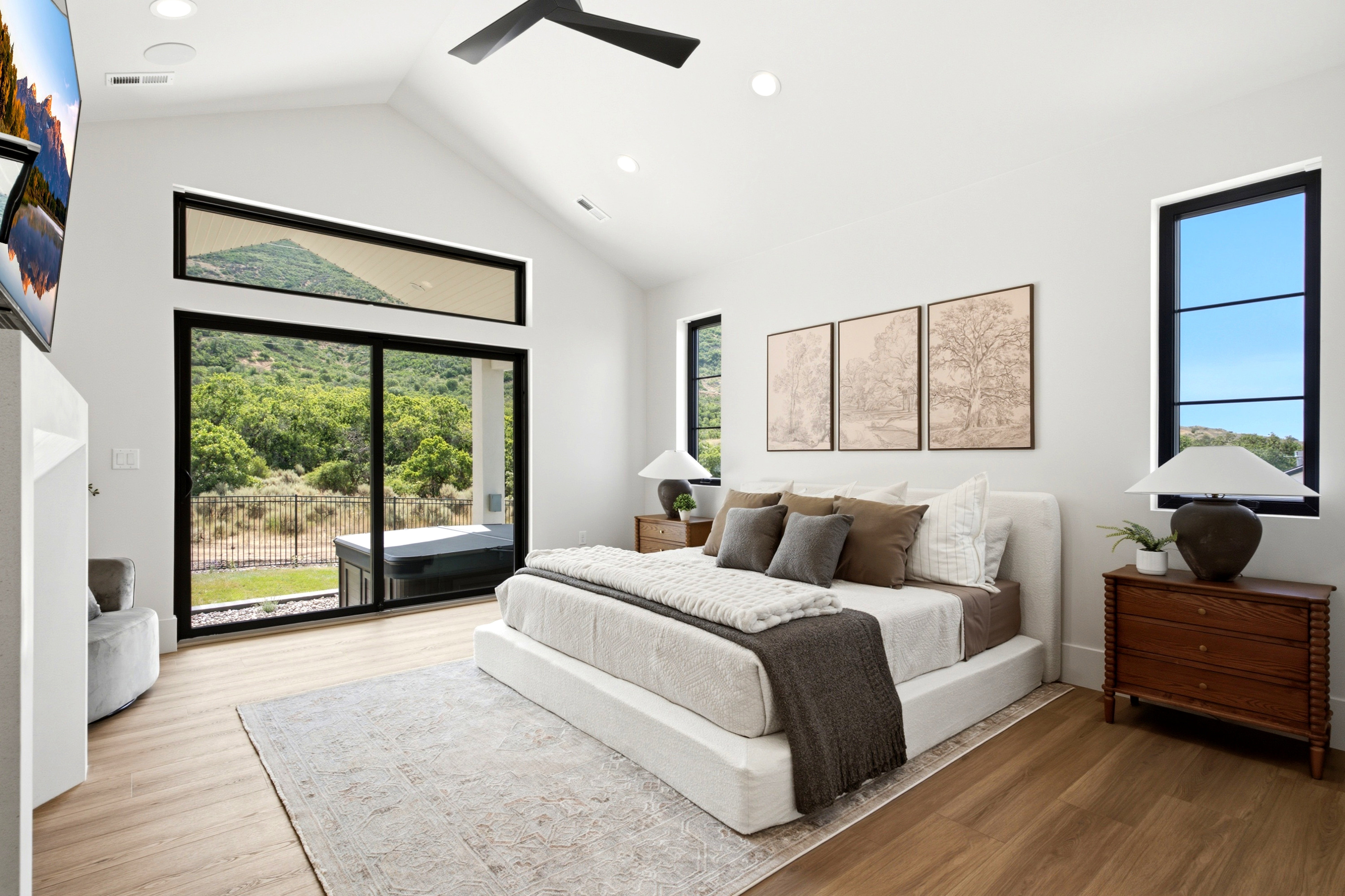 Vaulted ceilings with recessed lighting and a ceiling fan