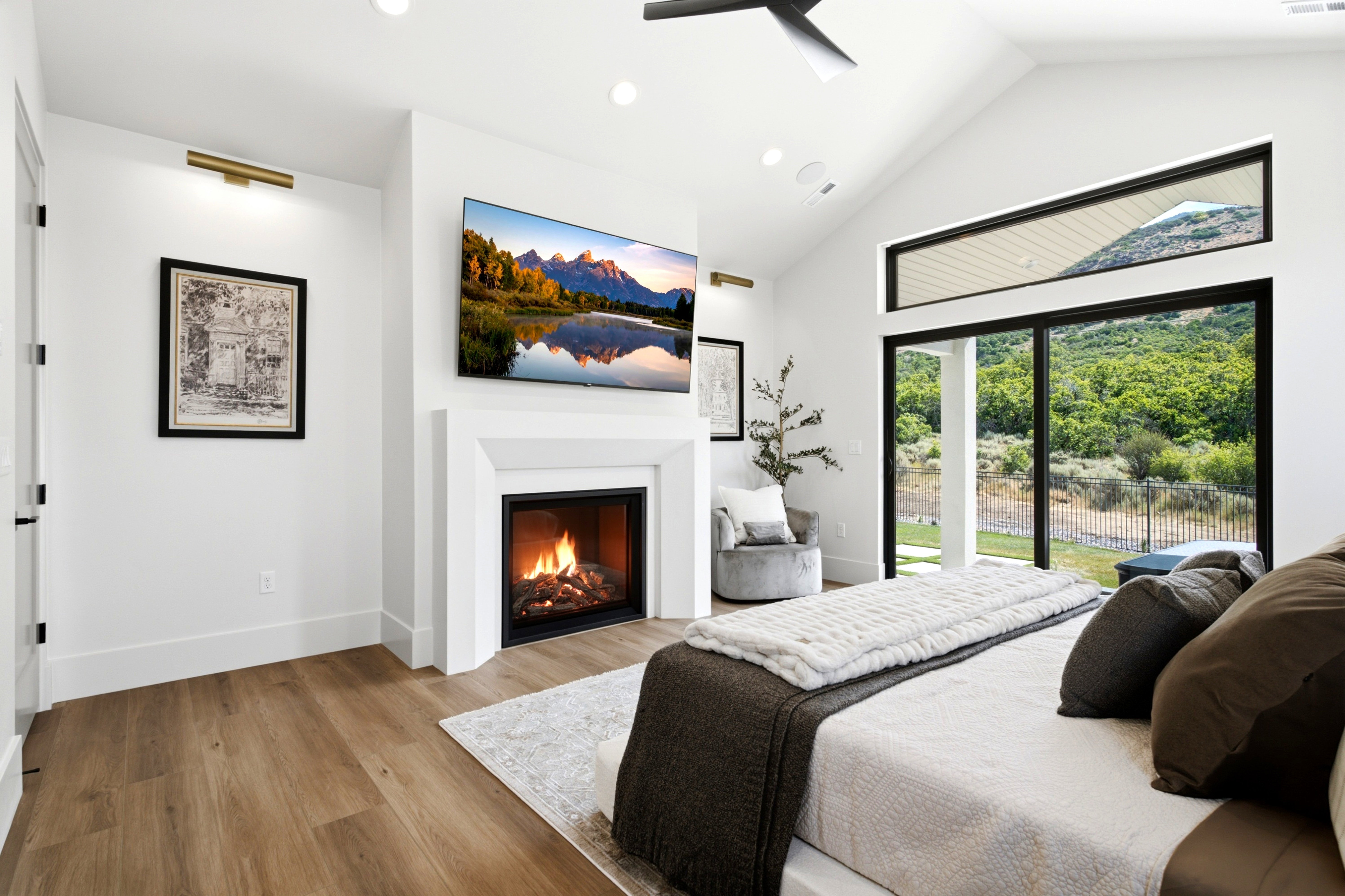 Spacious room featuring vaulted ceilings, a built-in fireplace, and wood-finish flooring