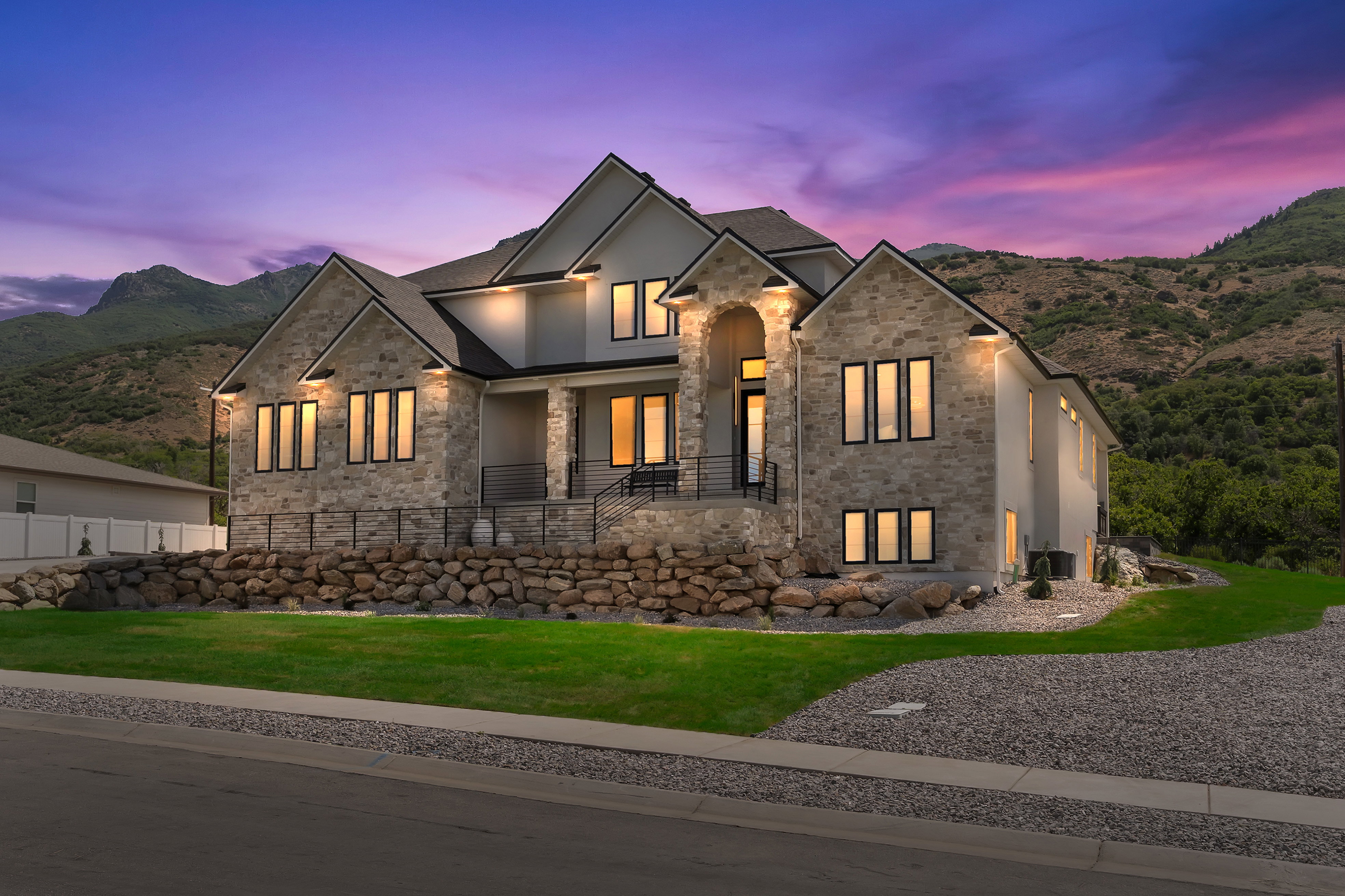 Stone and stucco exterior with multiple gables and black-trimmed windows