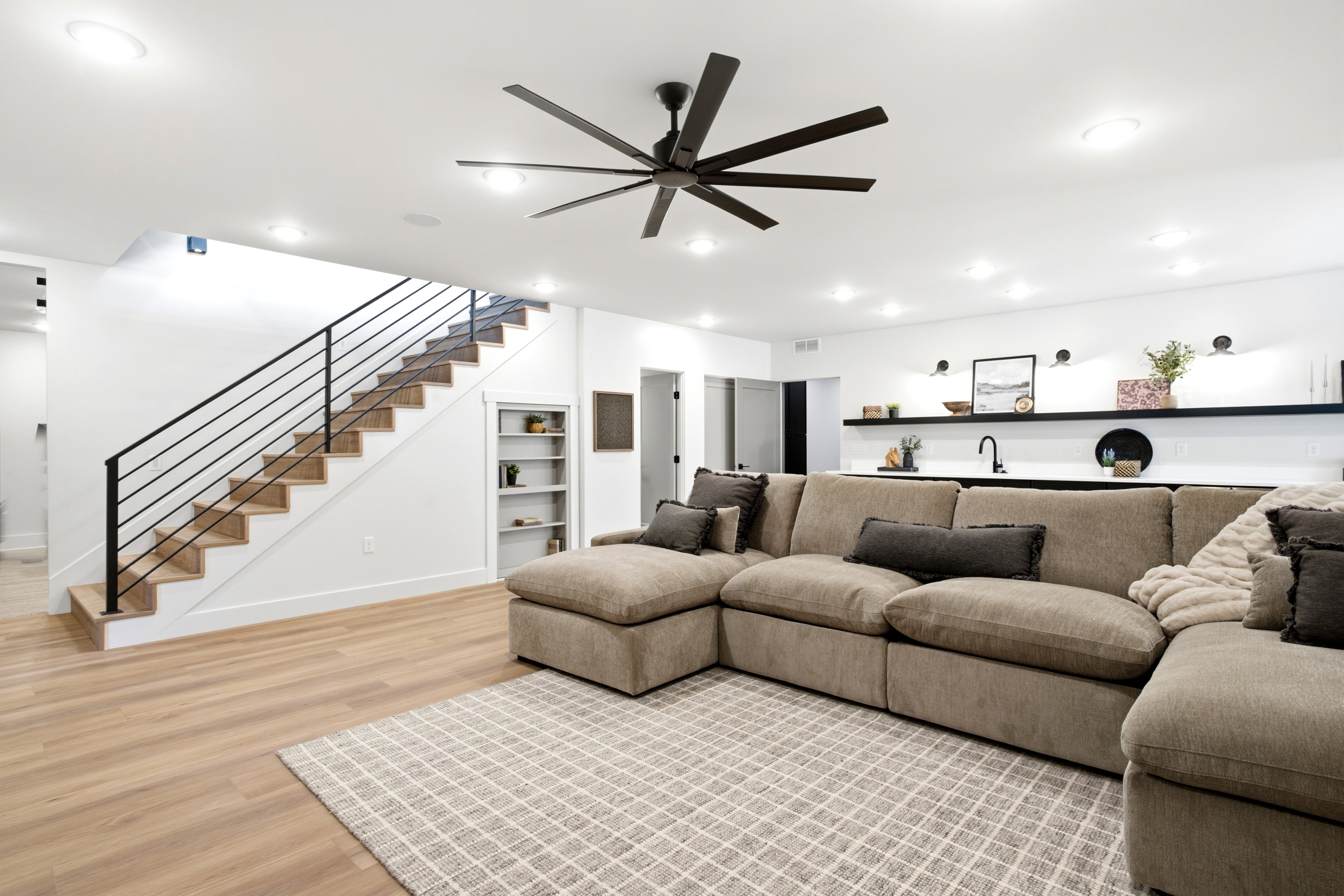 Light wood-finish flooring with a patterned area rug