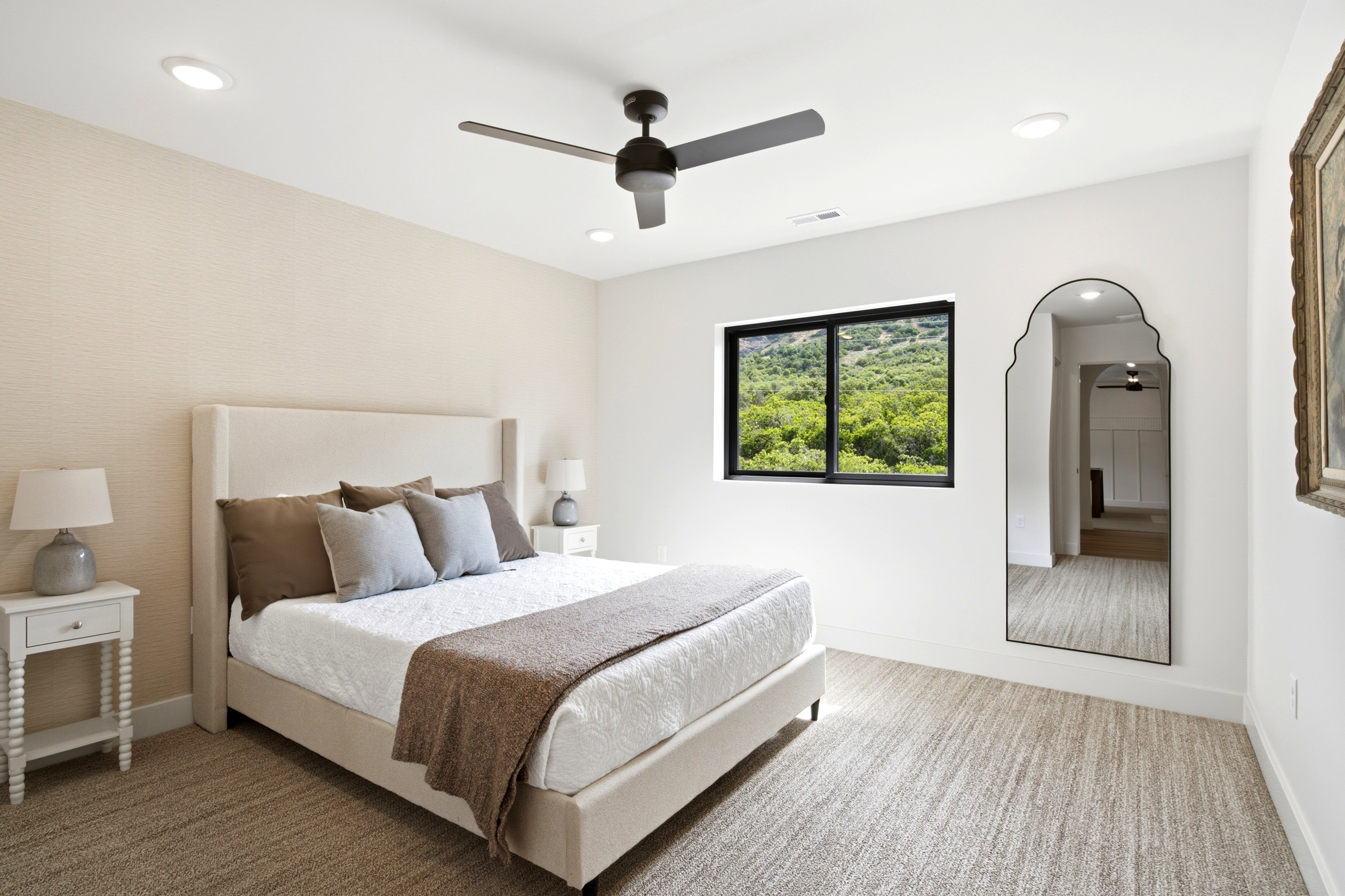 Recessed lighting and a contemporary ceiling fan provide ambient illumination