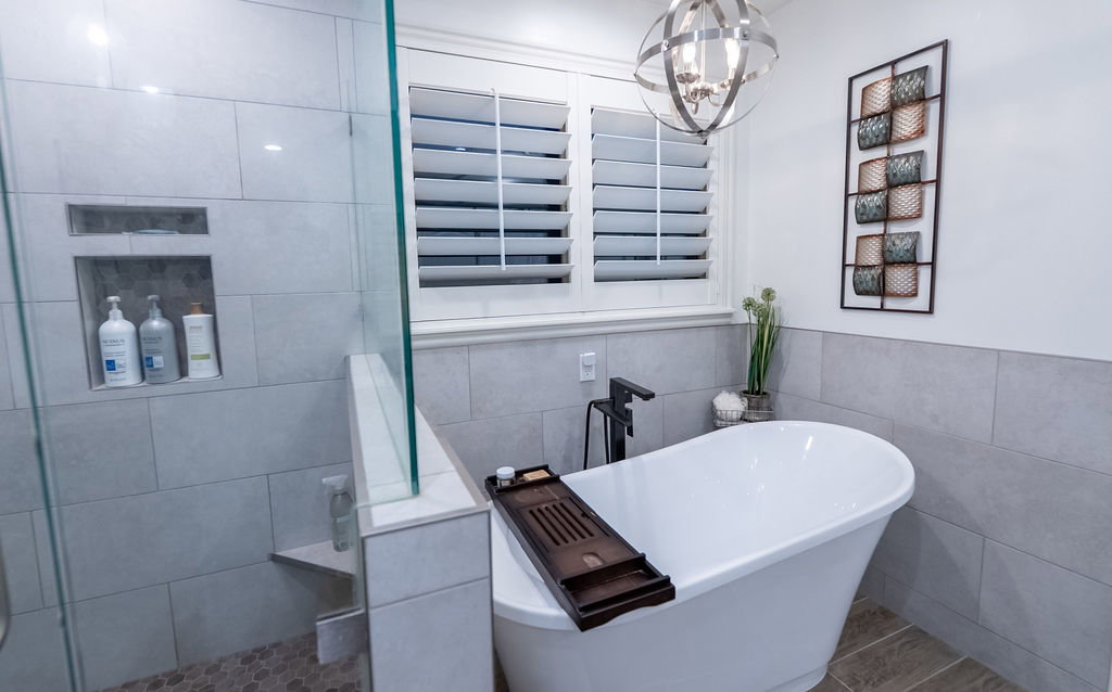 Freestanding soaking tub with a floor-mounted matte black faucet