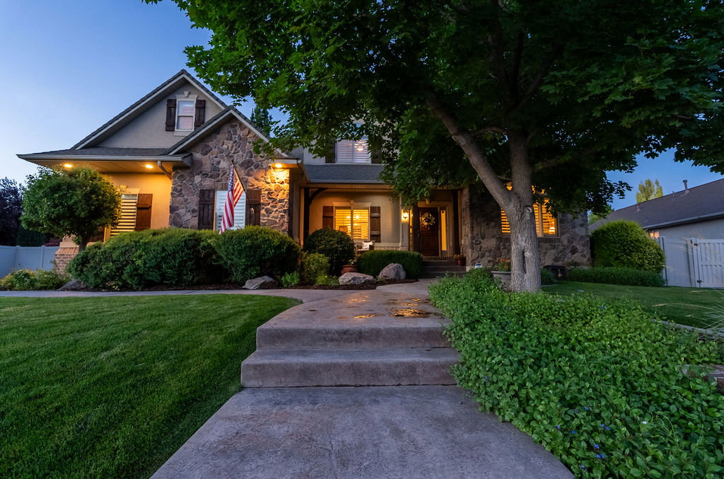 Stone and stucco exterior with dark shutters