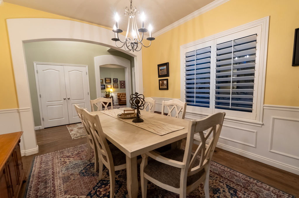 Dining area featuring a classic chandelier and wood-finish flooring