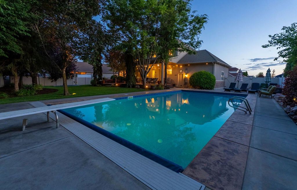Rectangular swimming pool with a diving board and integrated steps