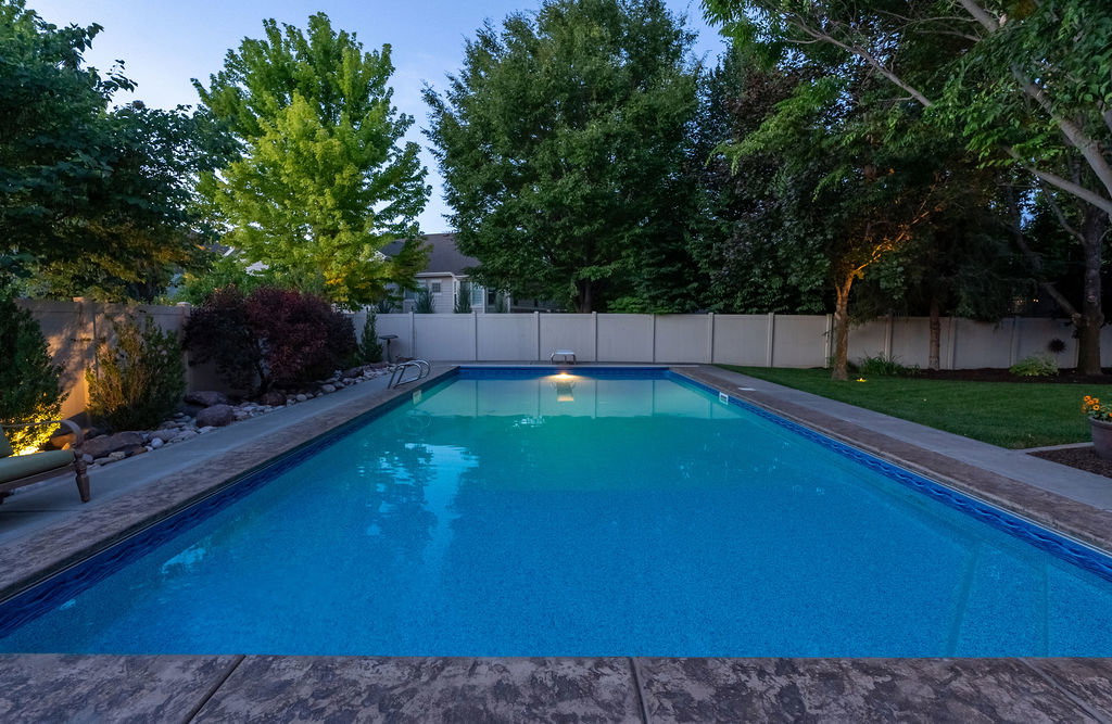 Rectangular swimming pool featuring a patterned blue liner and tiled coping