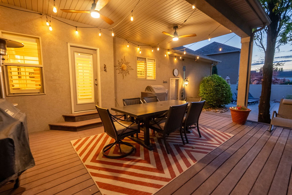 Expansive outdoor deck featuring composite flooring and a covered patio area