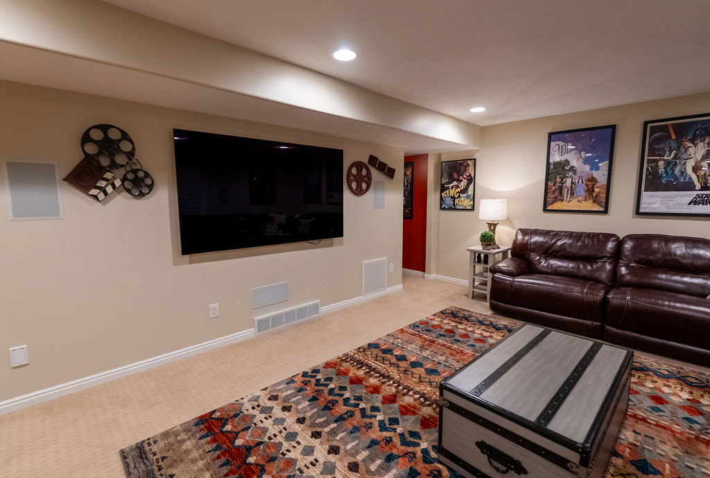 Recessed lighting illuminates this versatile room with plush carpet flooring