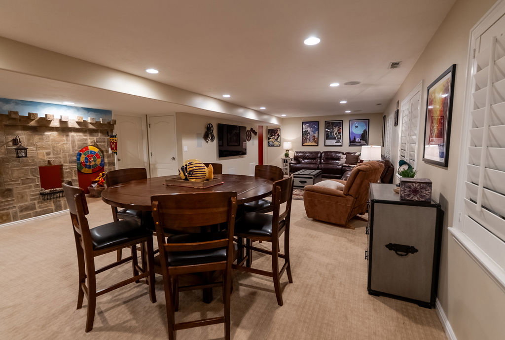 Spacious lower-level entertainment area featuring recessed lighting and plush carpet flooring