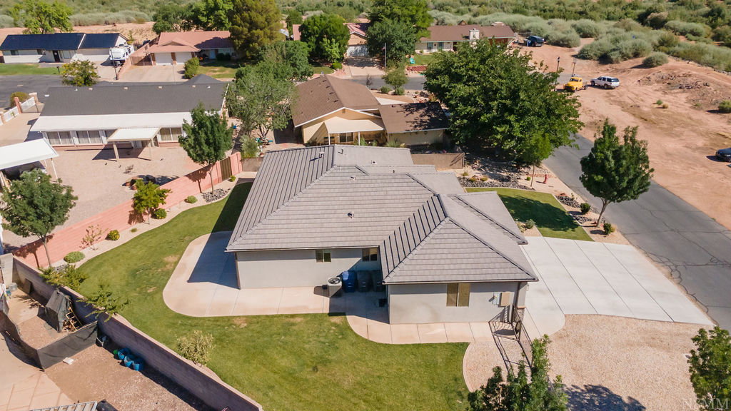 Aerial perspective showcasing a property with a gray tile roof and stucco siding