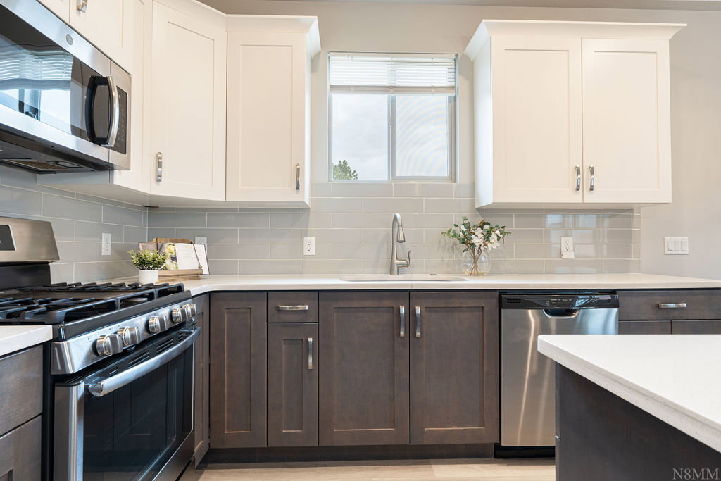 Kitchen featuring a stainless steel gas range, microwave, and dishwasher
