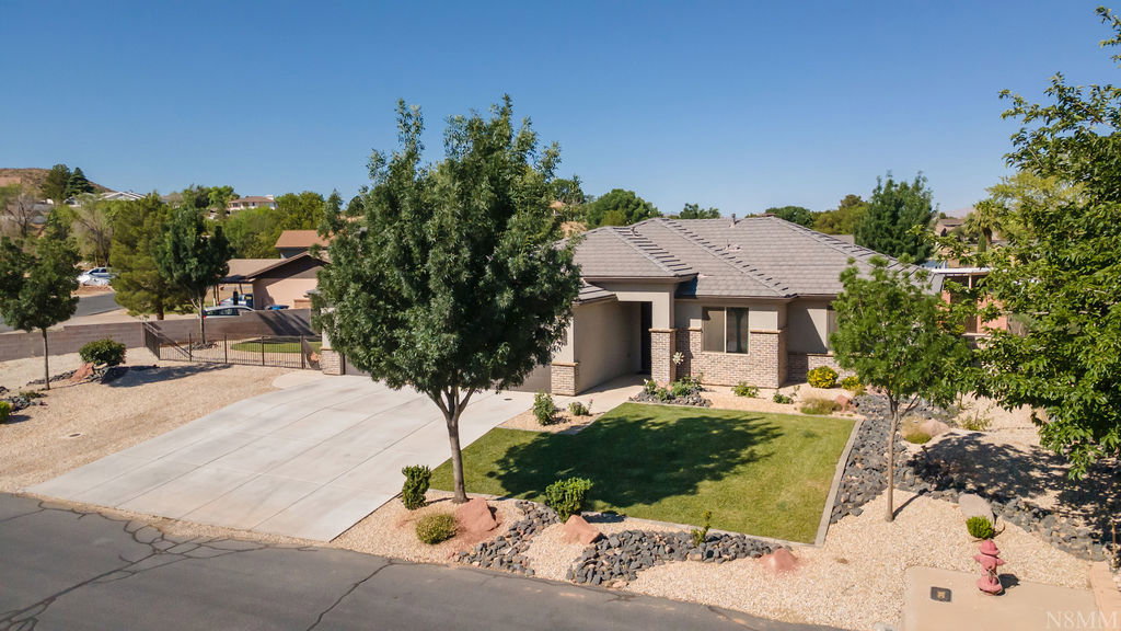 Exterior facade featuring a tiled roof, stucco siding, and stone accents