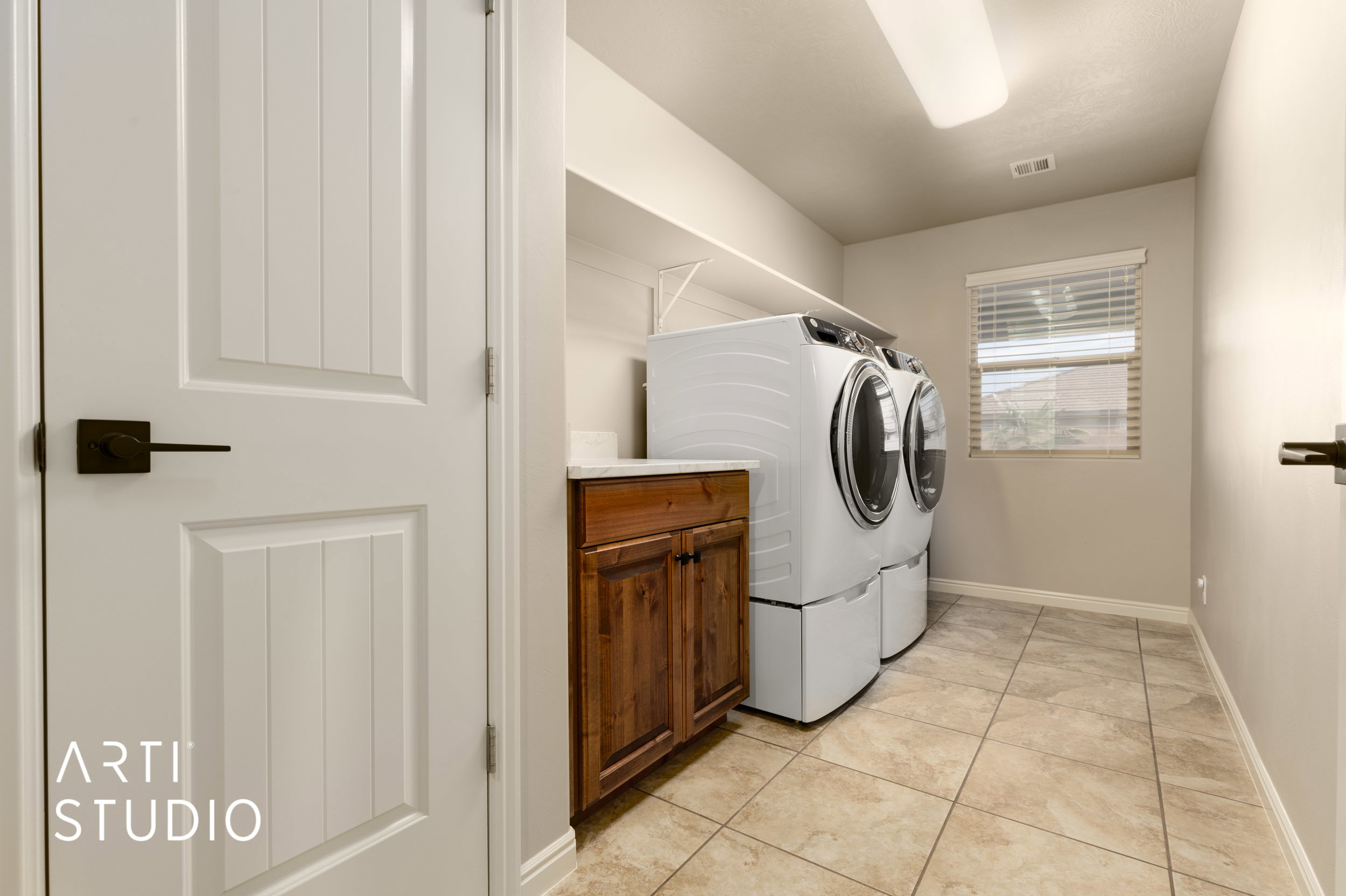 Large laundry room with closet, shelving and cabinet storage