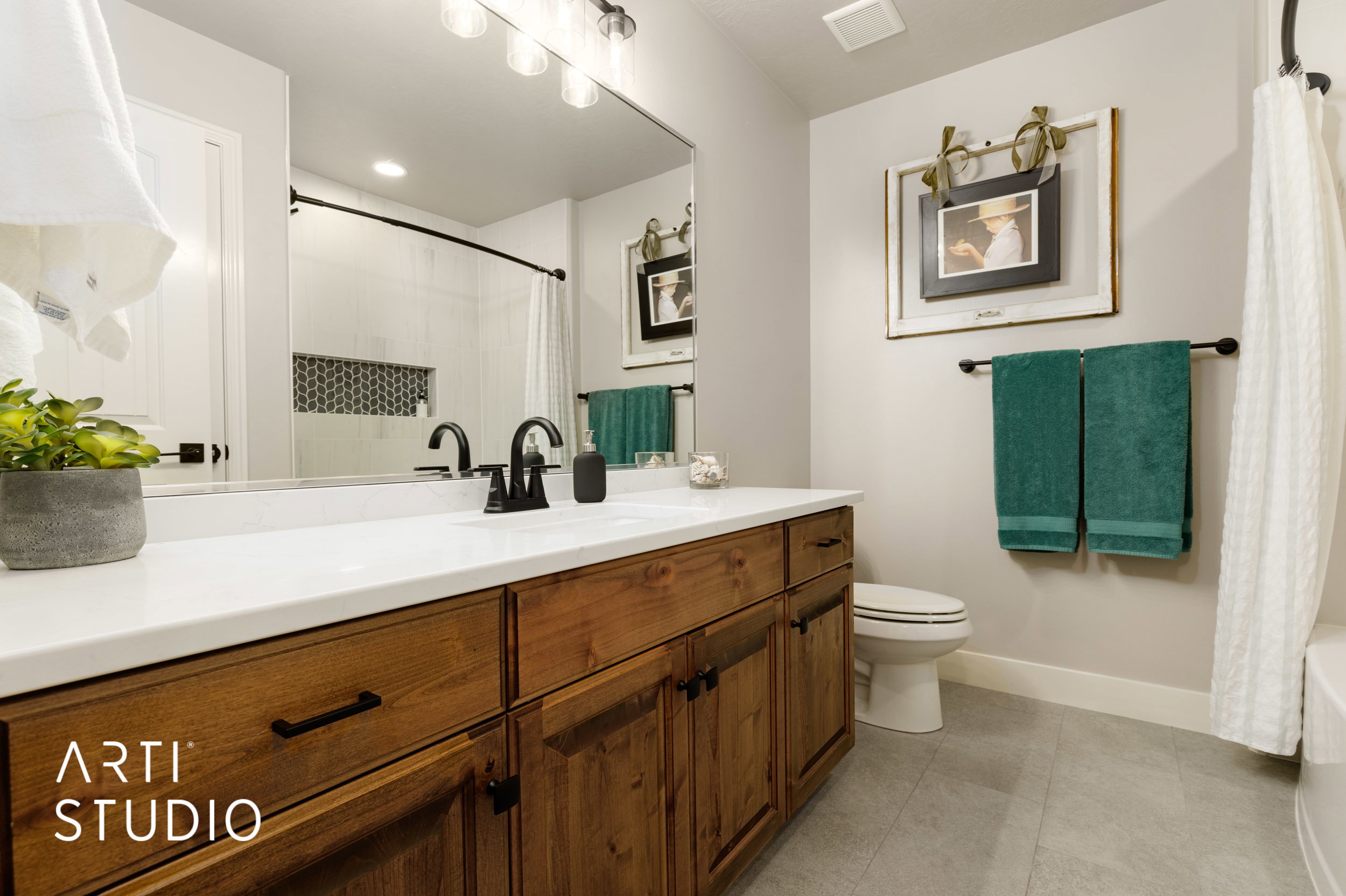 Extra long vanity with a white countertop and wood-finish cabinetry