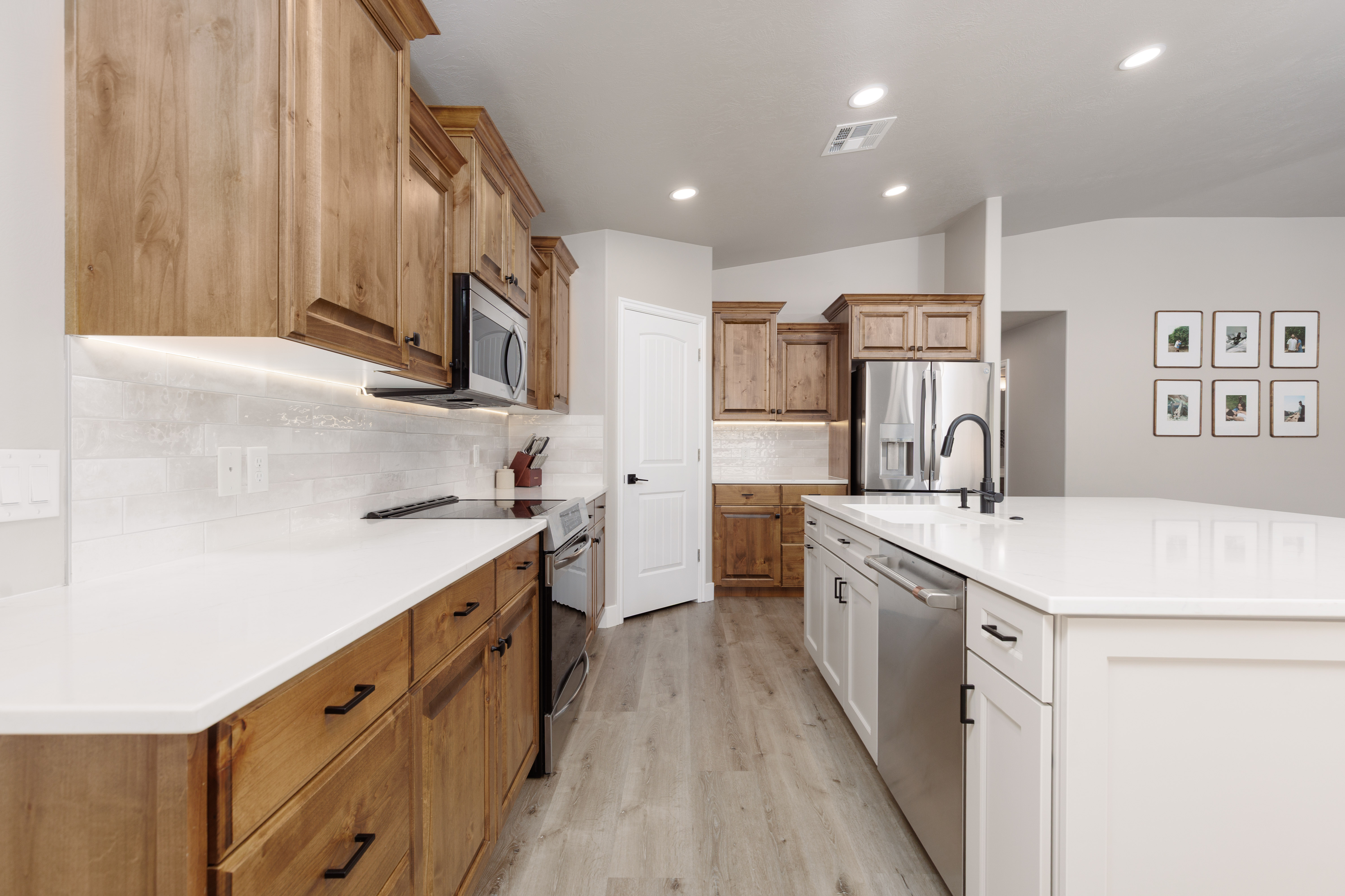 Kitchen featuring a large central island with white cabinetry and a light-toned countertop