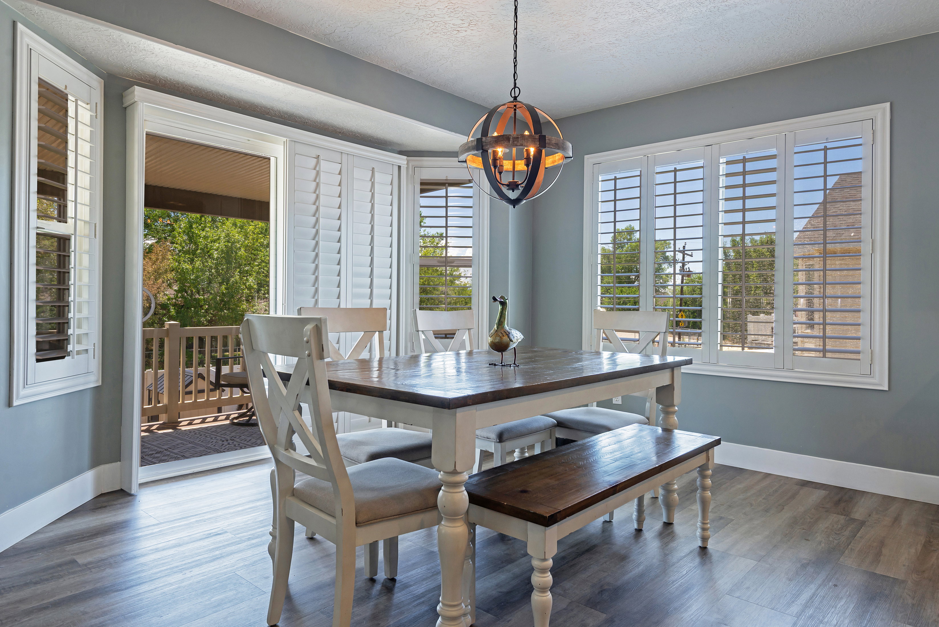 Dining area with wood-finish flooring and light blue walls