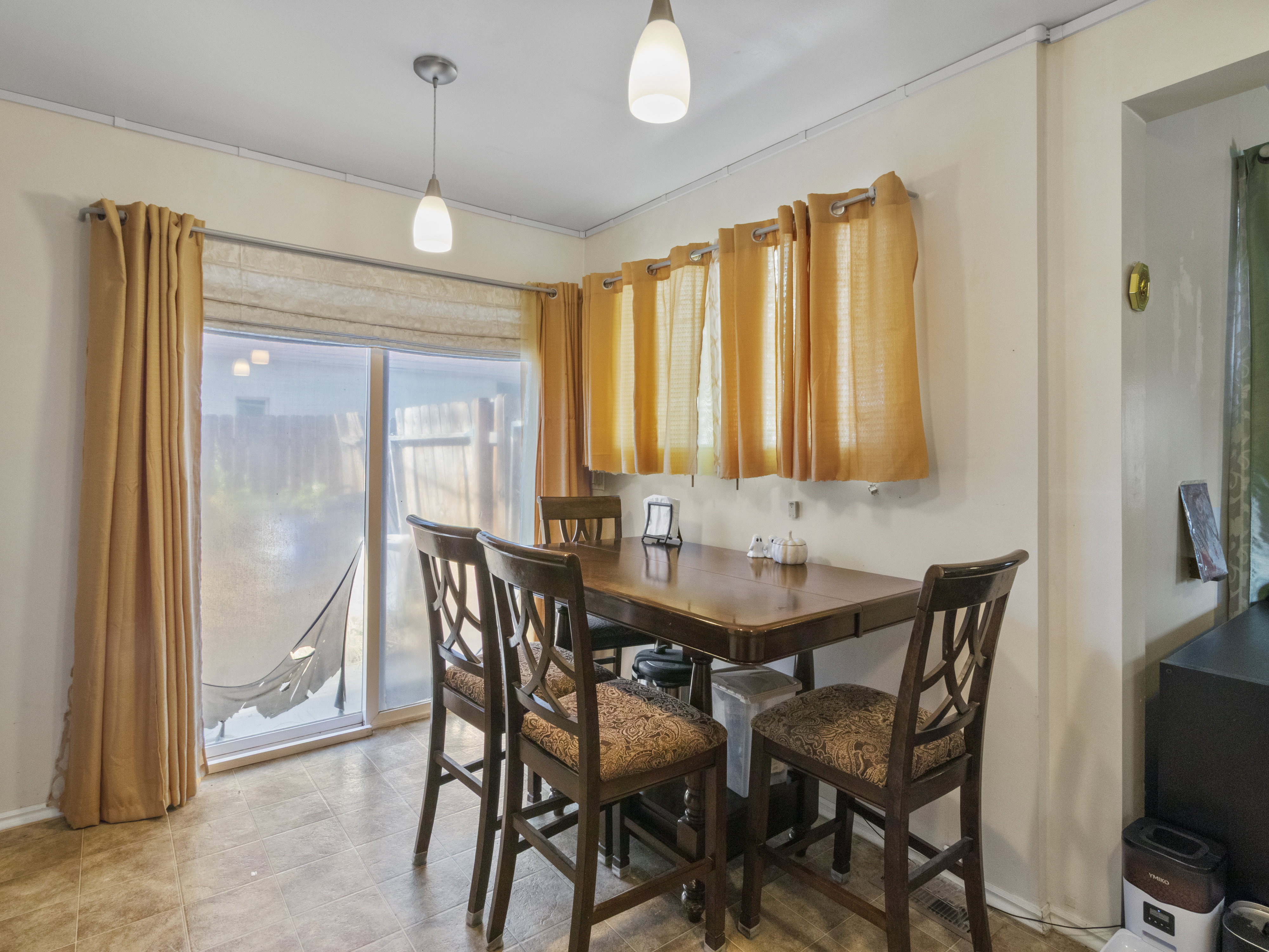 Dining area featuring tile flooring and pendant lighting