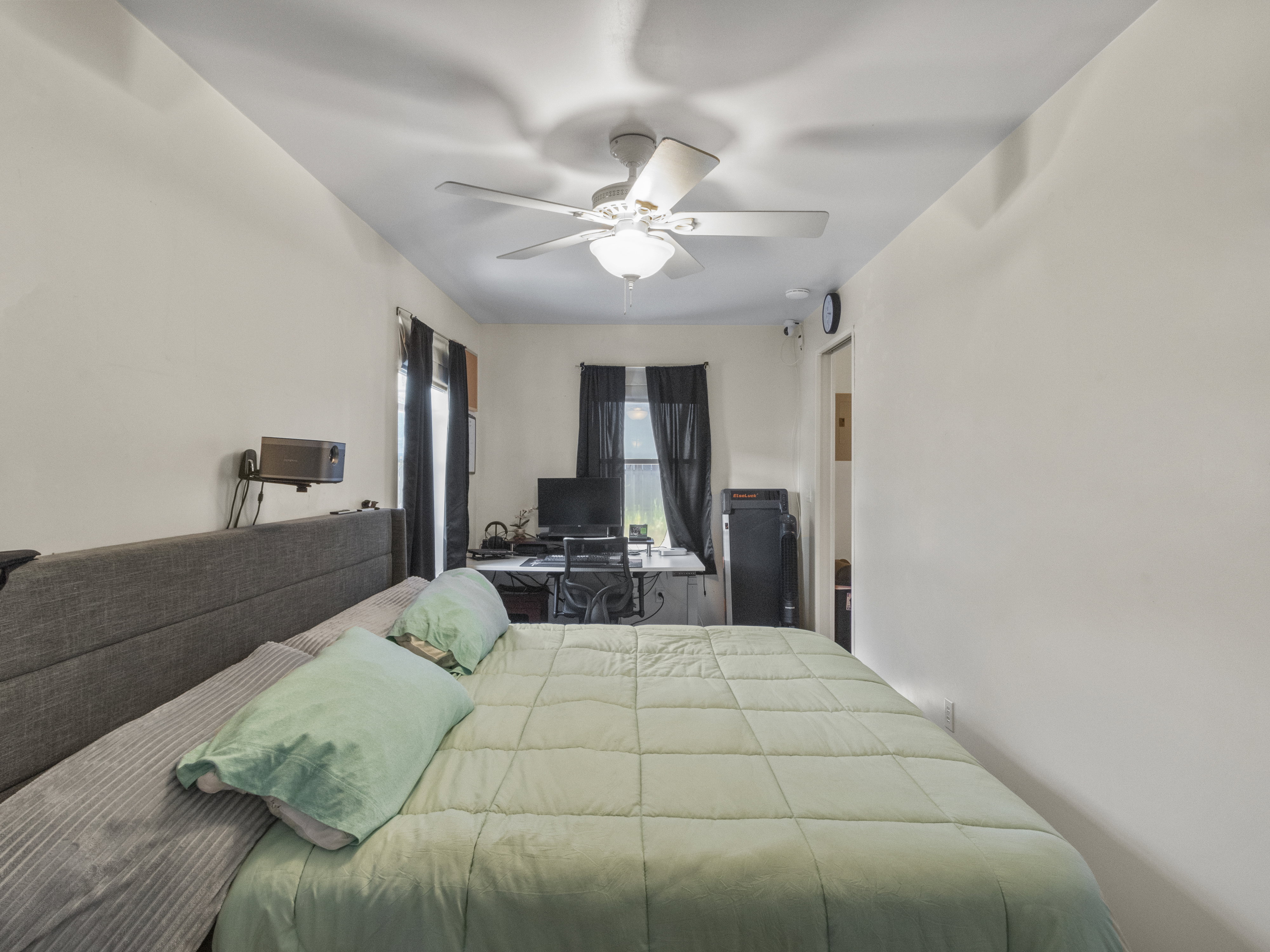 White walls with a ceiling fan and recessed lighting
