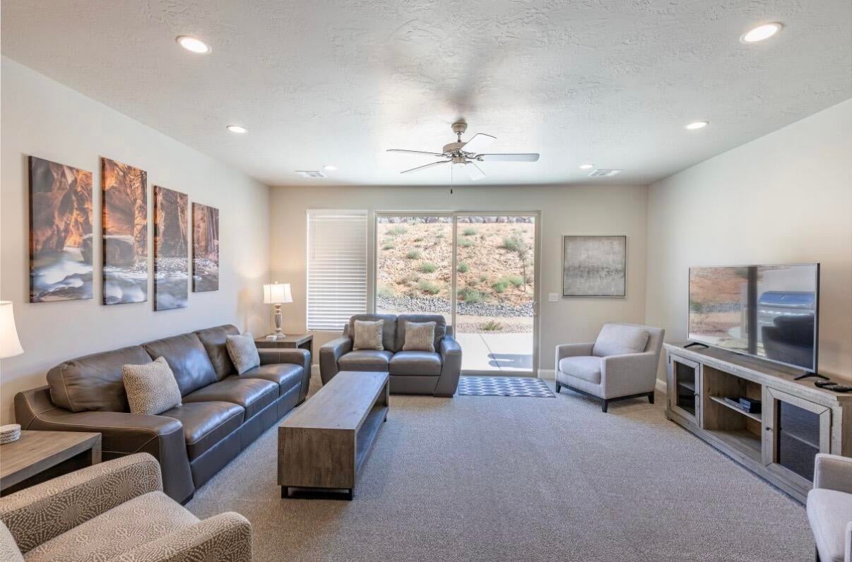 Carpeted living space with recessed lighting and a ceiling fan