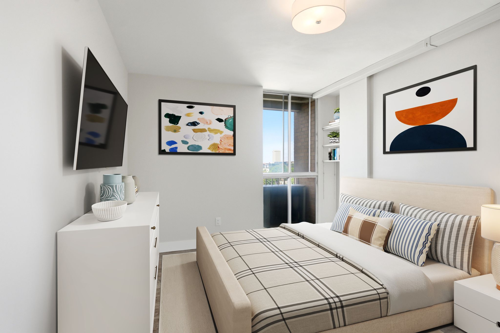 Bright bedroom with a full-height window, built-in shelving, wood-finish flooring, a wall-mounted television, and a flush-mount ceiling light fixture