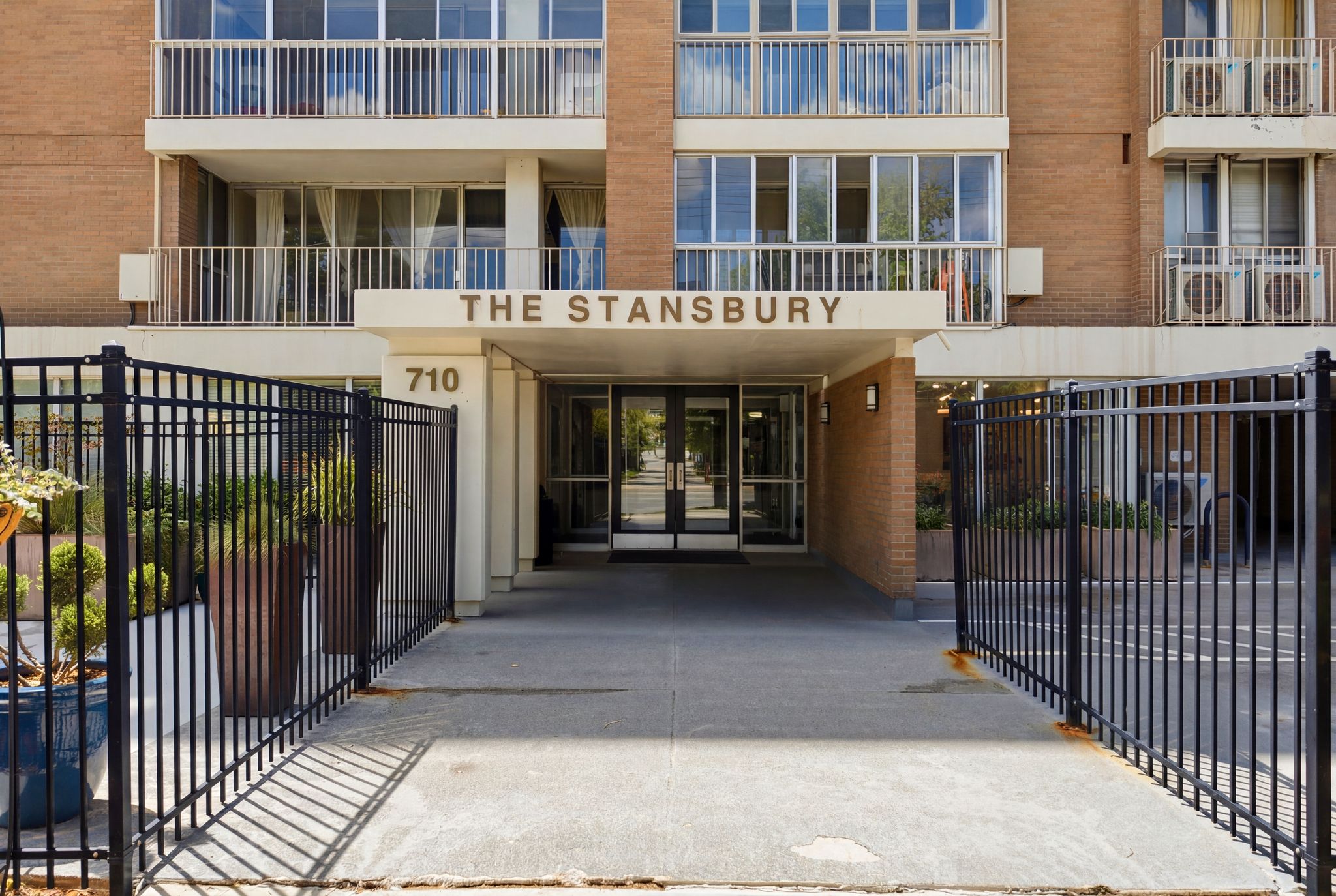 Building entrance featuring "THE STANSBURY" signage and "710" address