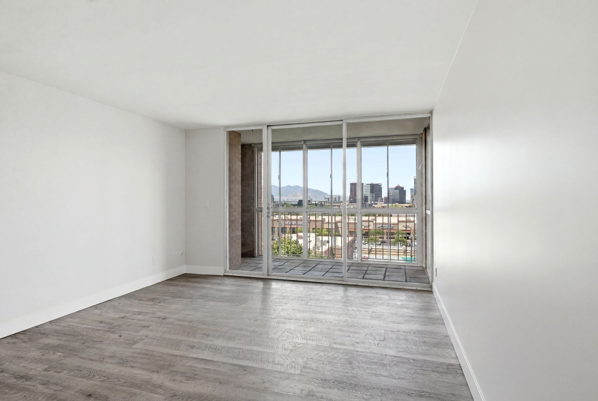 Living space featuring wood-finish flooring and white walls