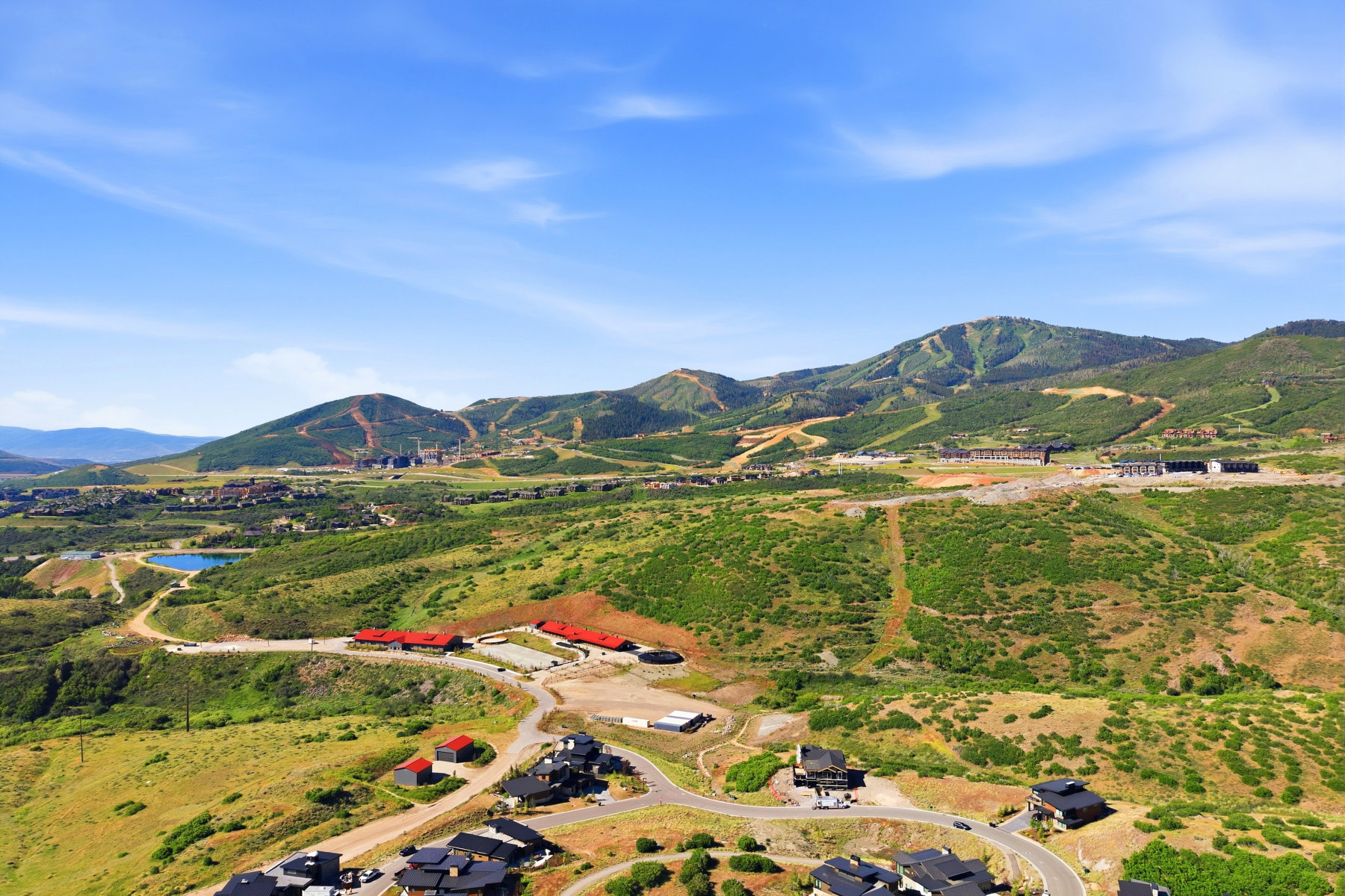 Expansive mountain landscape featuring varied terrain and multiple structures