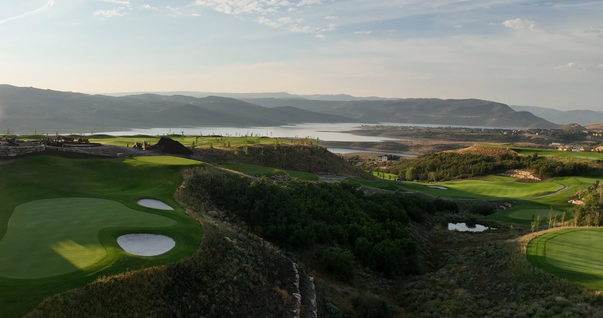 Expansive golf course terrain featuring manicured greens and sand traps