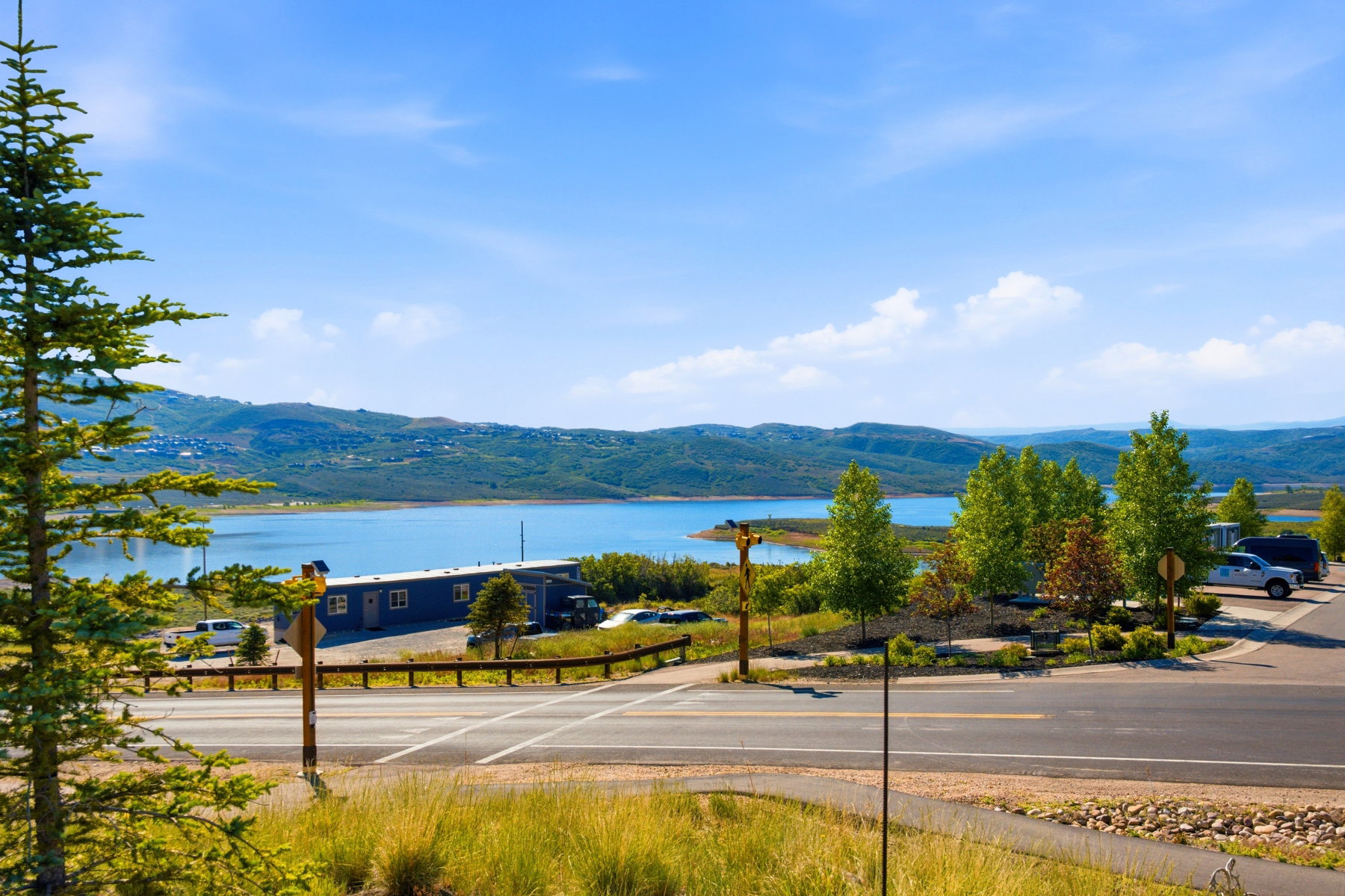 Expansive water body framed by distant hills and a clear blue sky