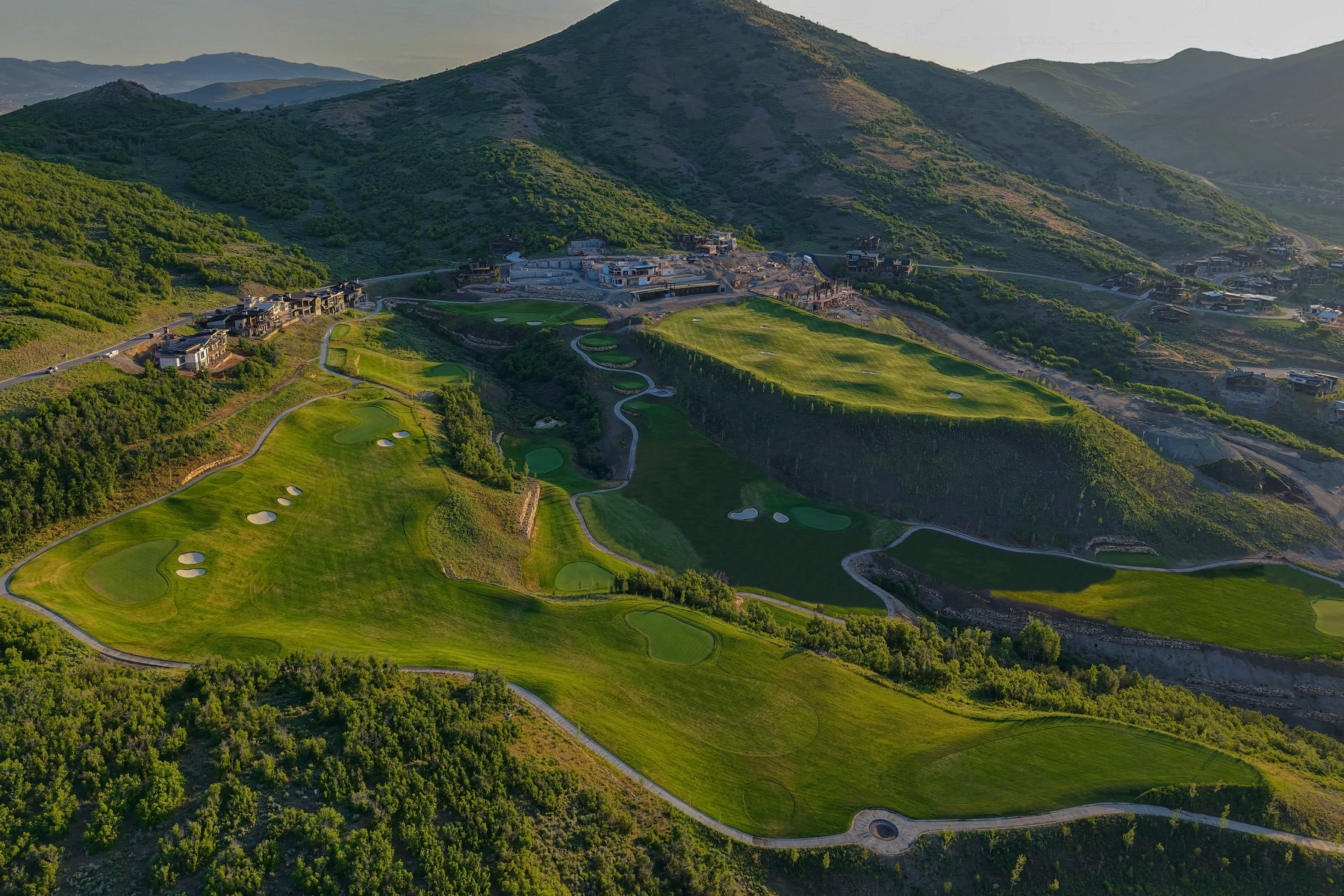 Expansive golf course landscape with multiple greens and sand traps