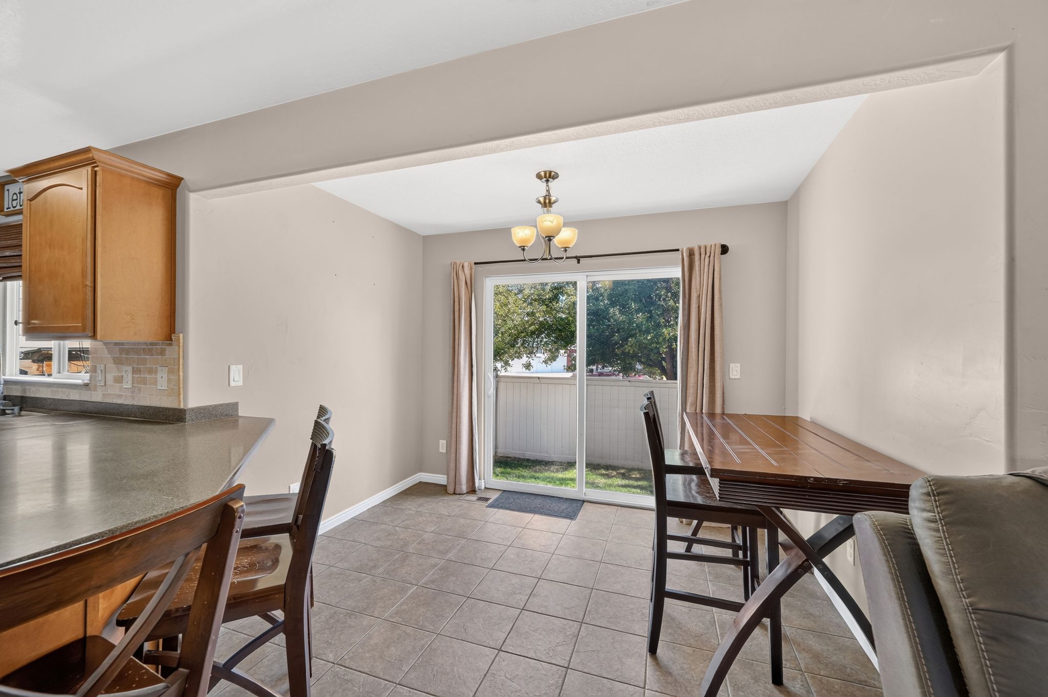 Dining area with tile flooring and a ceiling-mounted light fixture