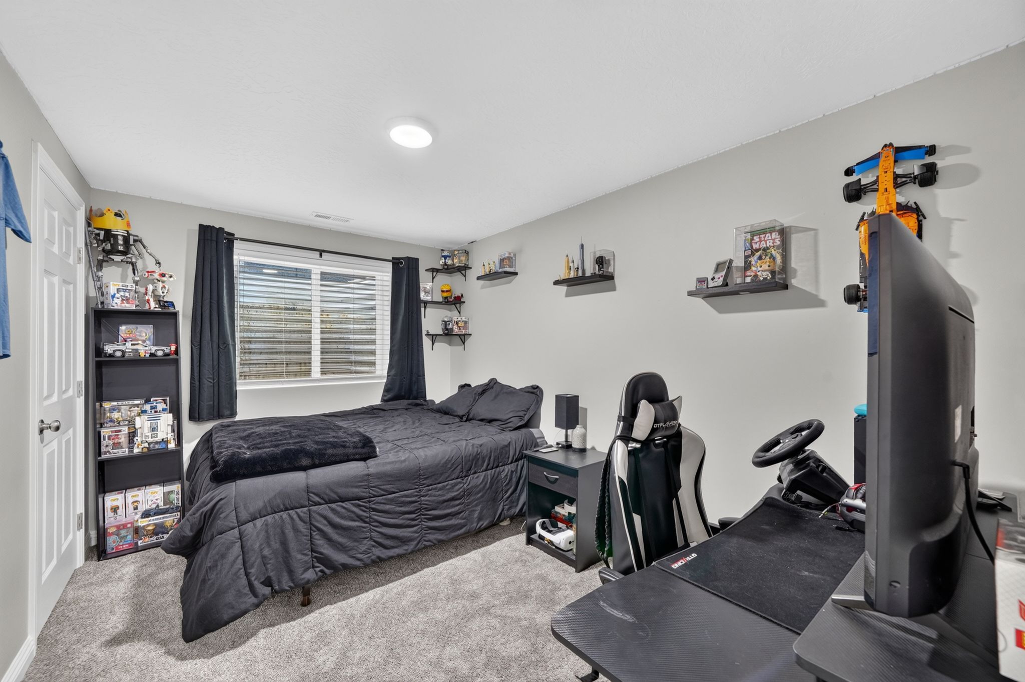 Bedroom featuring light gray walls and plush gray carpeting