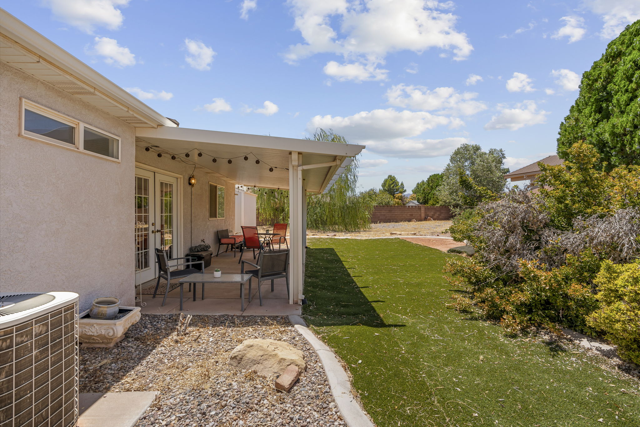 Covered patio featuring string lighting and direct outdoor access through French doors