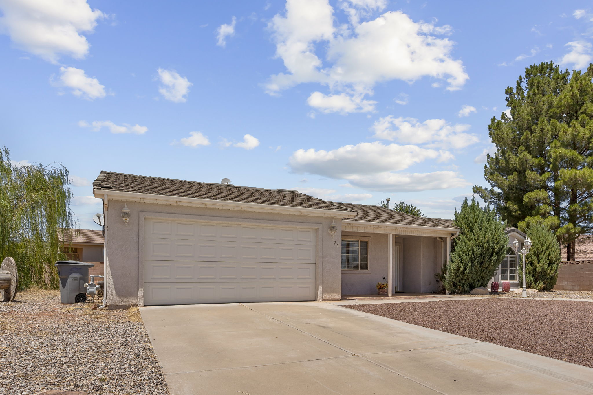 Single-story residence featuring a two-car garage, concrete driveway, and stucco exterior