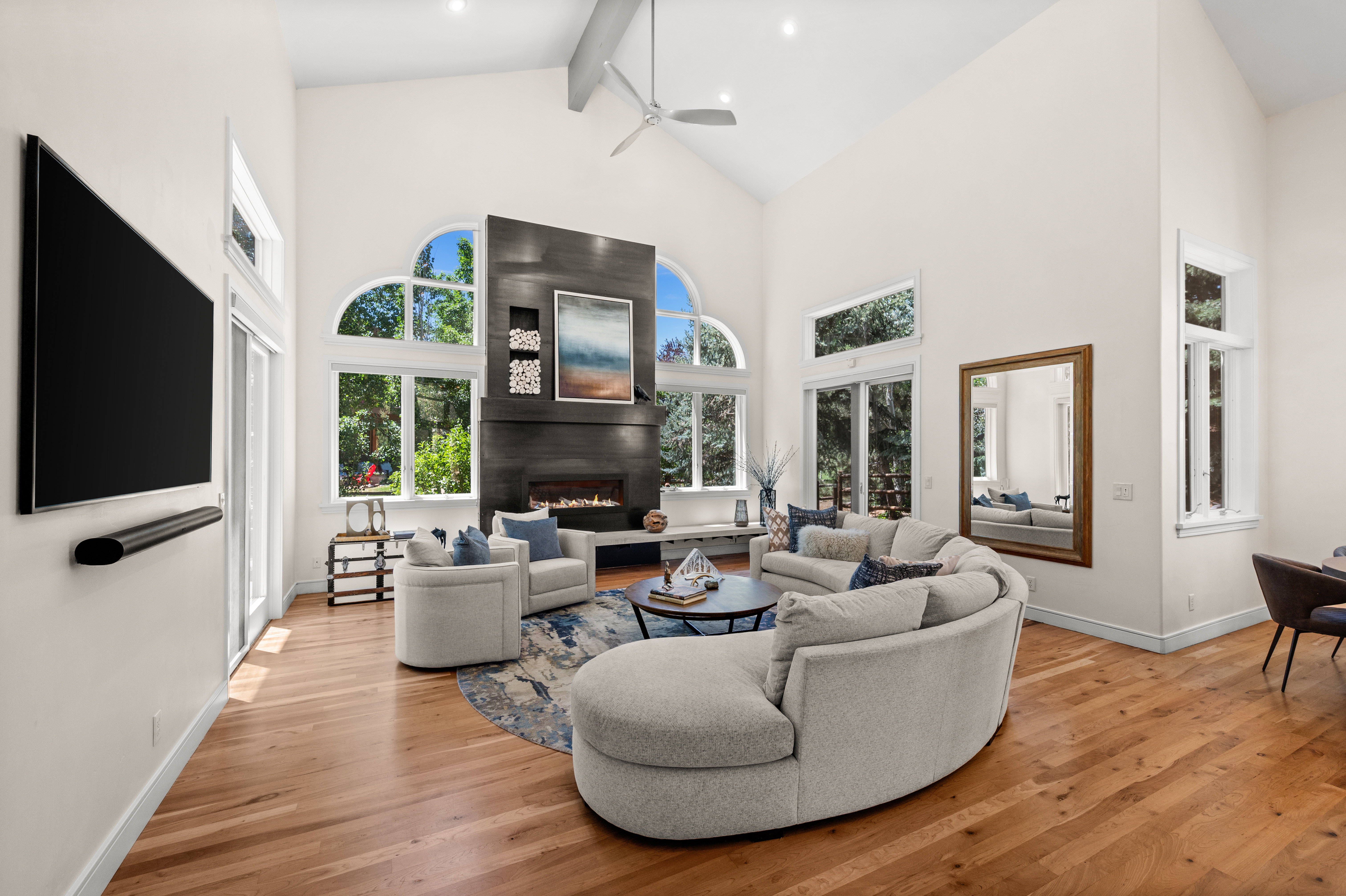 Vaulted ceilings with exposed beams and a ceiling fan