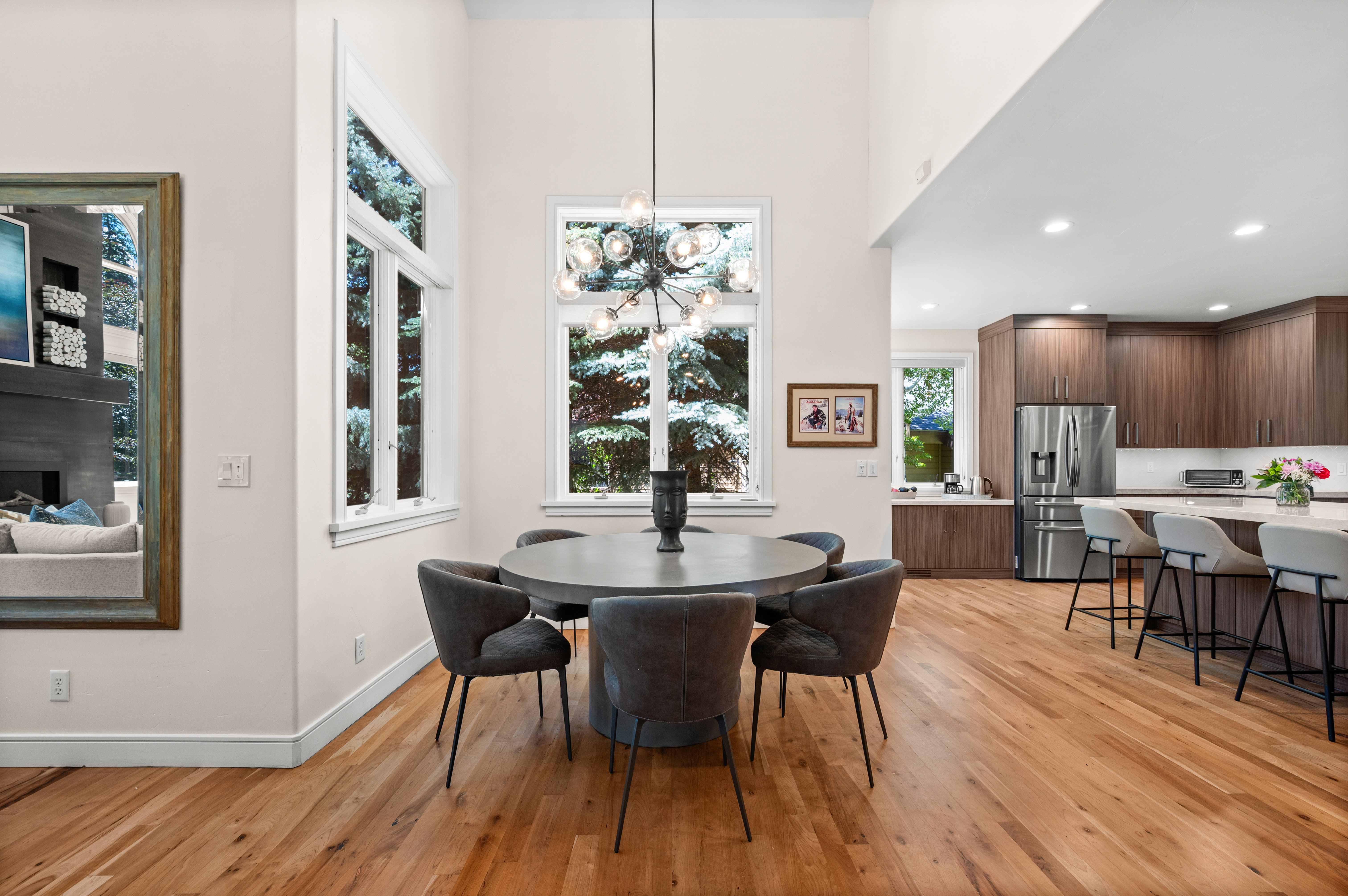 Open-concept dining and kitchen area with light wood-finish flooring