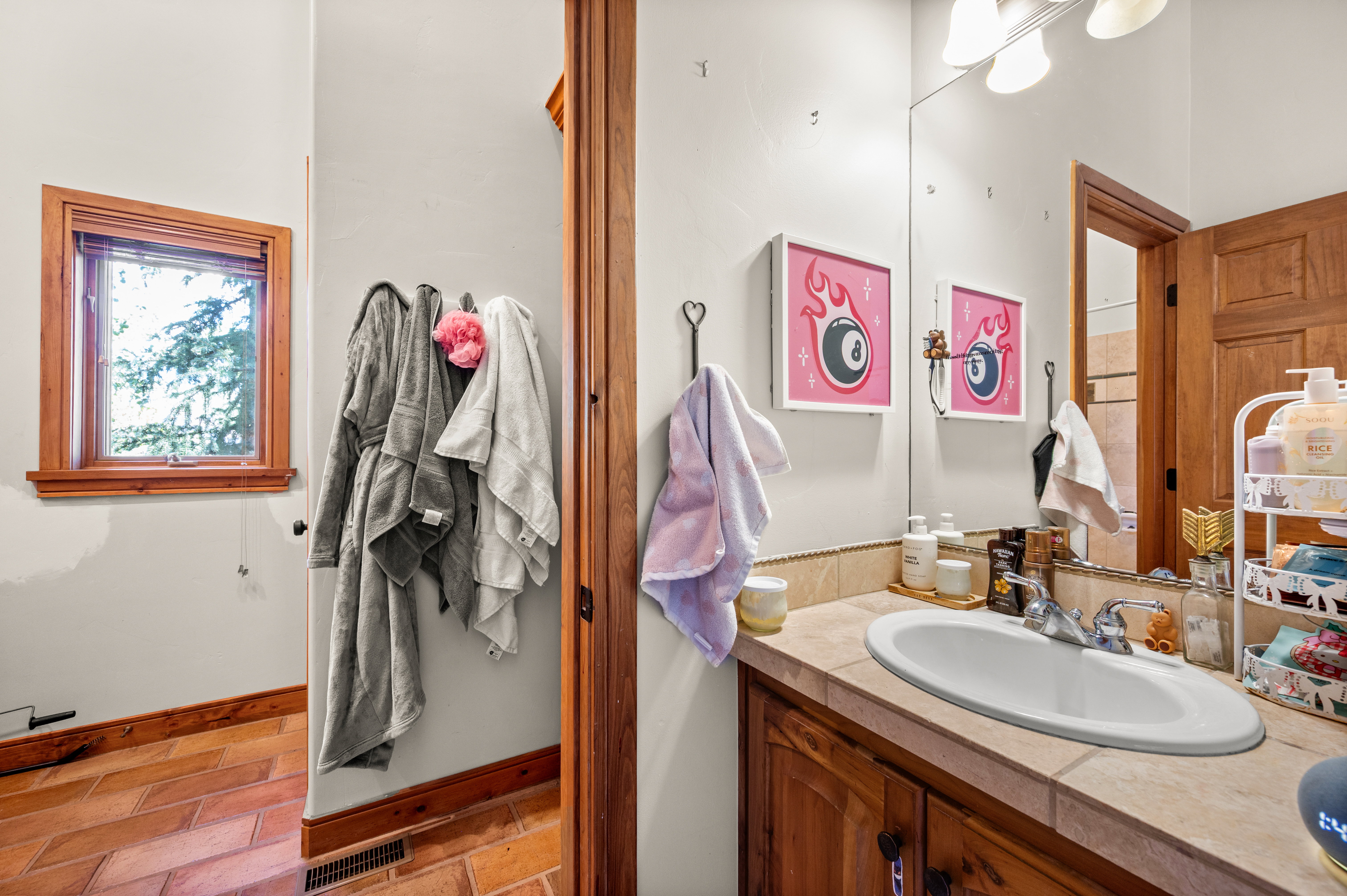 Bathroom vanity with a built-in oval sink, dual-handle chrome faucet, and a large mirror