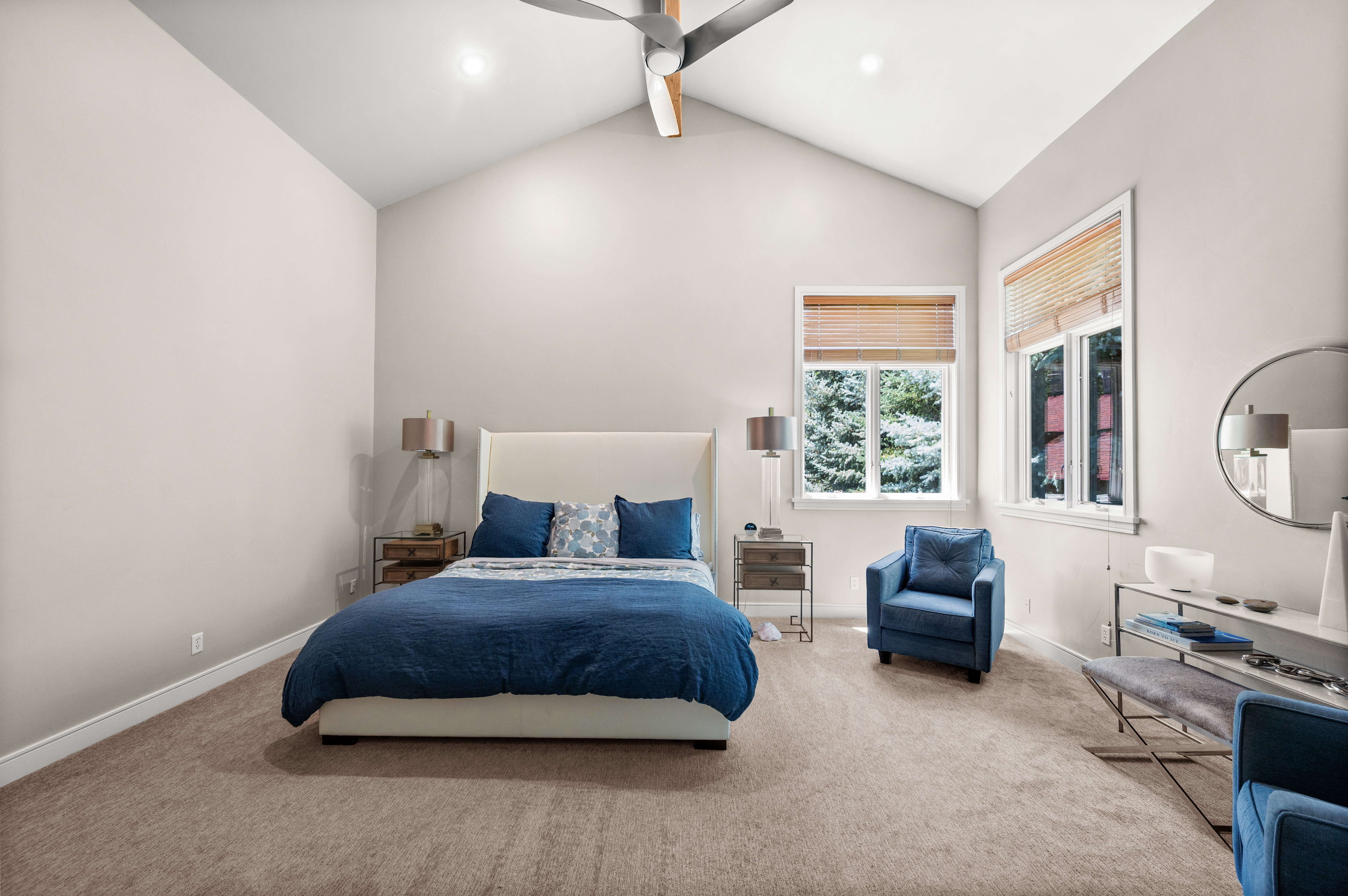 Vaulted ceilings with recessed lighting and a ceiling fan