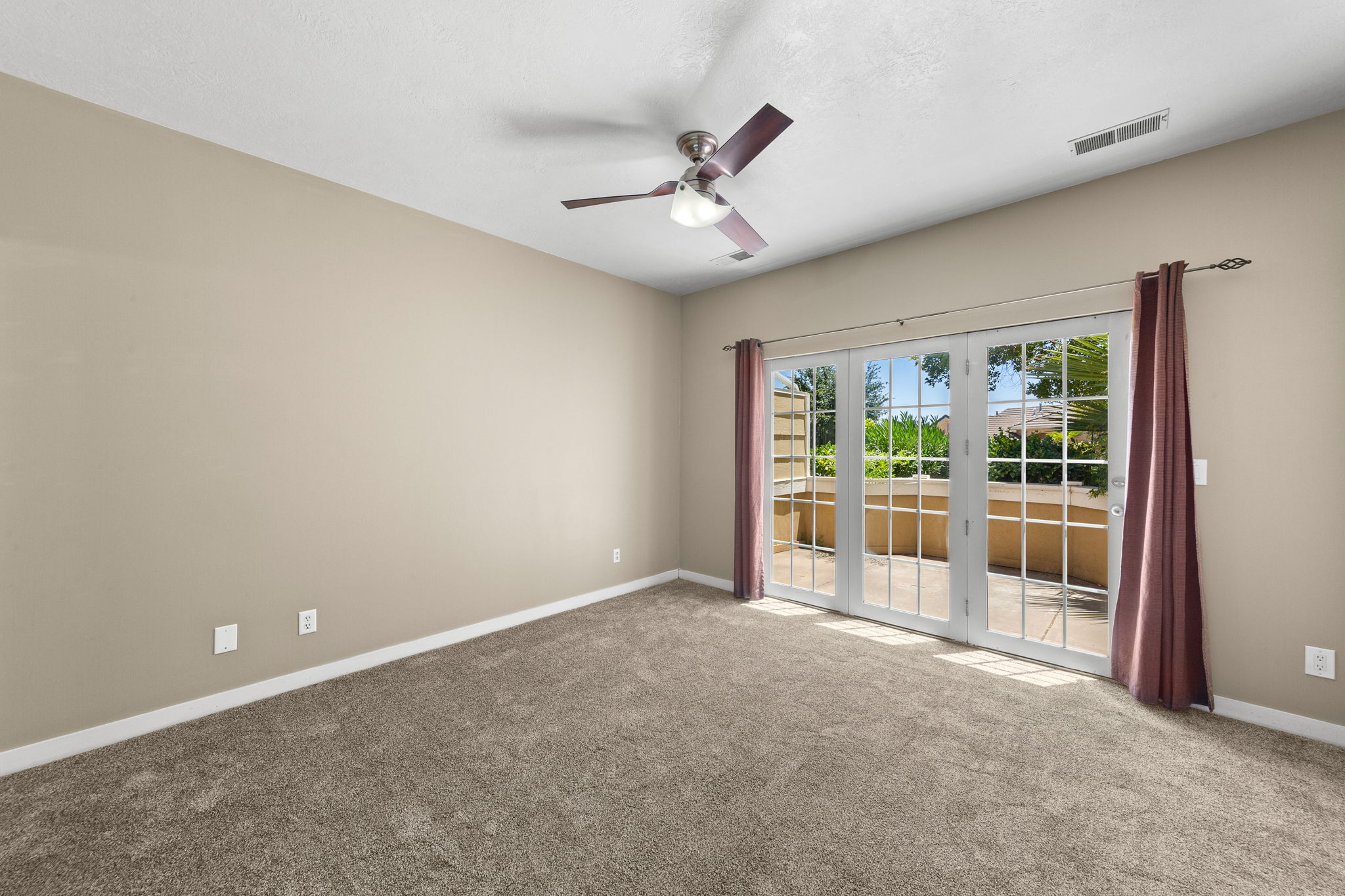 Spacious room featuring neutral carpeting and light beige walls